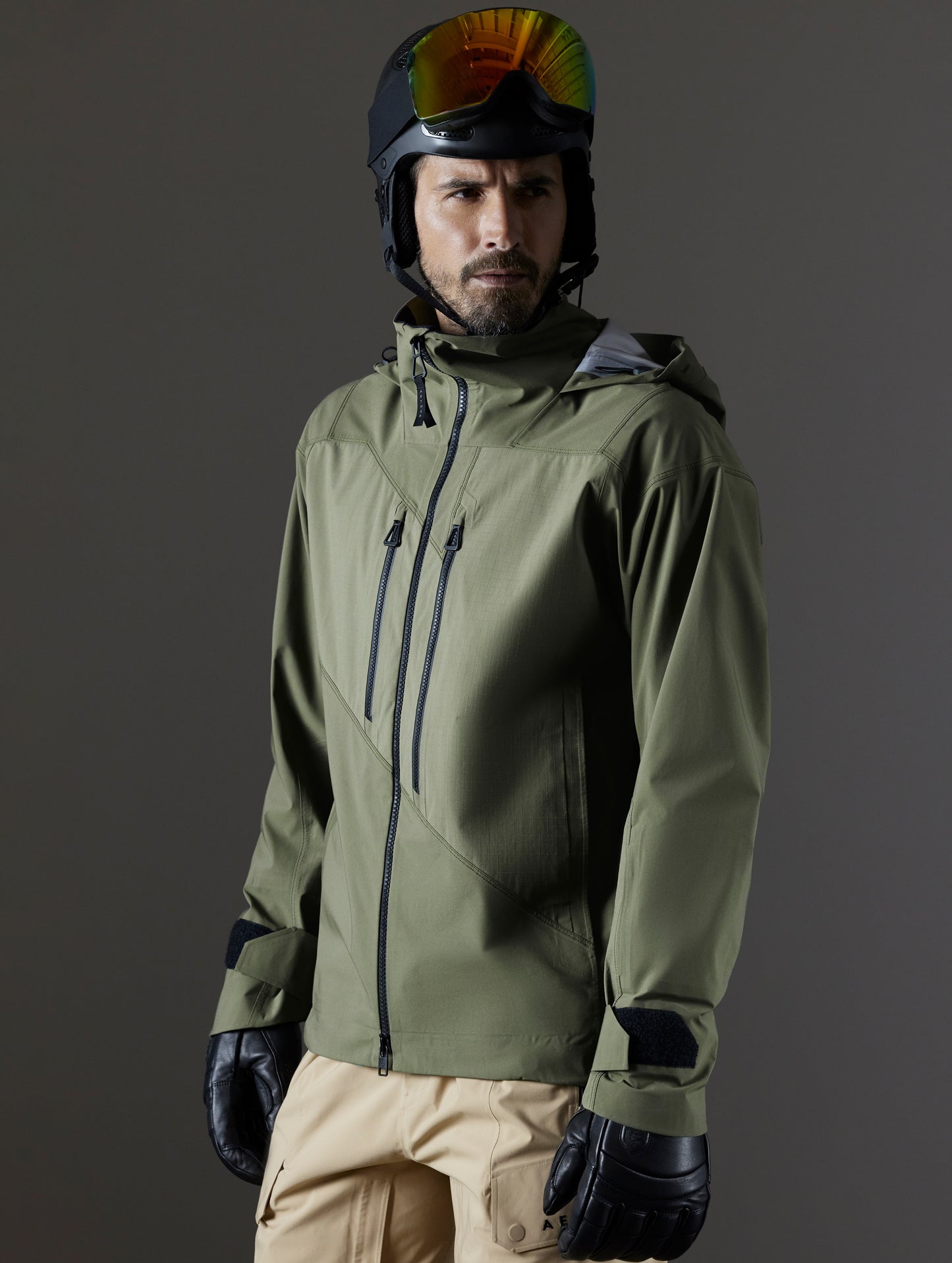 Front 3/4 body view of man wearing Maverick Snow-Shell Jacket in Fern Green from AETHER Apparel.
