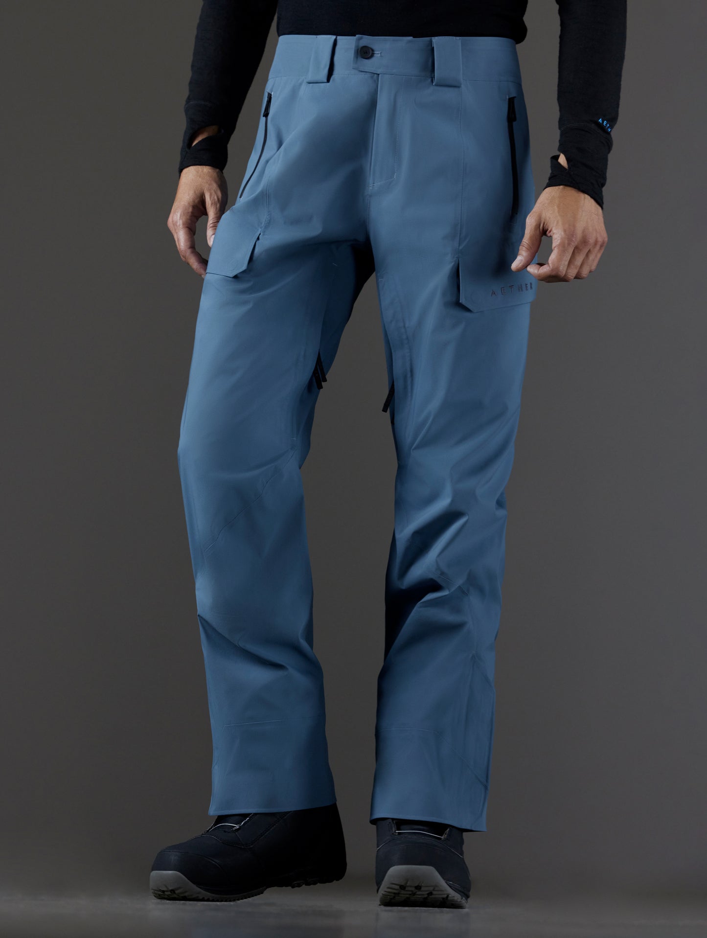 Front 3/4 lower body view of man wearing Maverick Snow-Shell Pant in Portal Blue from AETHER Apparel.