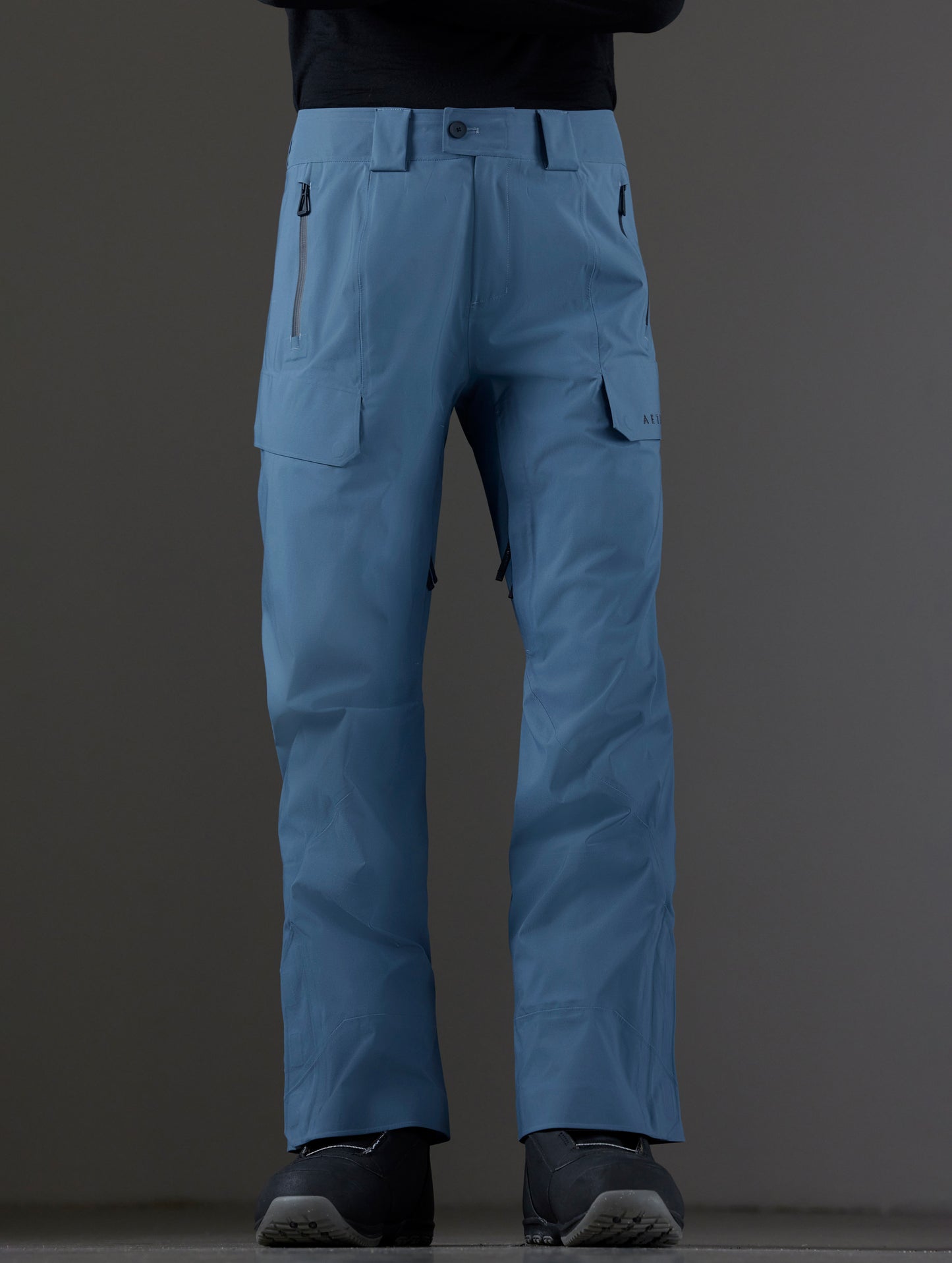 Front lower body view of man wearing Maverick Snow-Shell Pant in Portal Blue from AETHER Apparel.