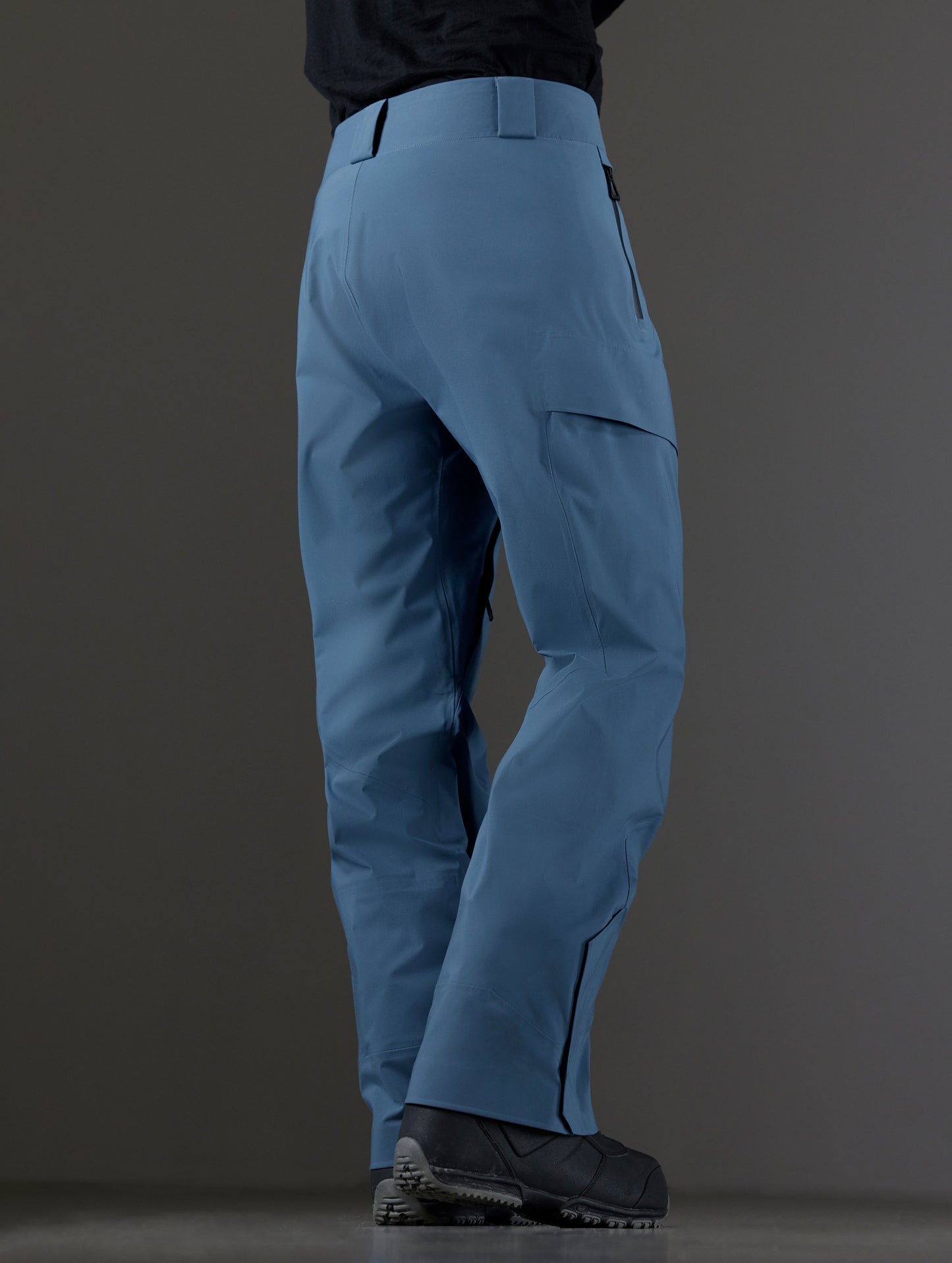 Rear 3/4 lower body view of man wearing Maverick Snow-Shell Pant in Portal Blue from AETHER Apparel.