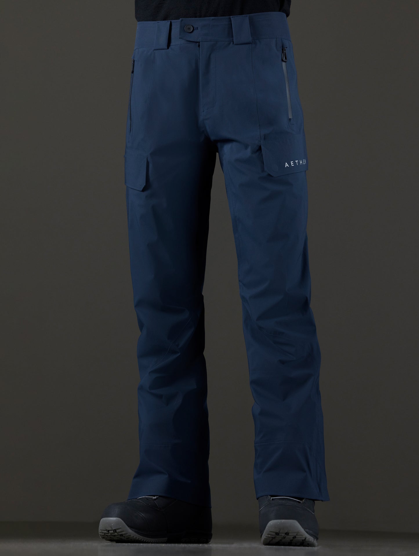 Front lower body view of man wearing Maverick Snow-Shell Pant in Total Eclipse dark blue from AETHER Apparel.