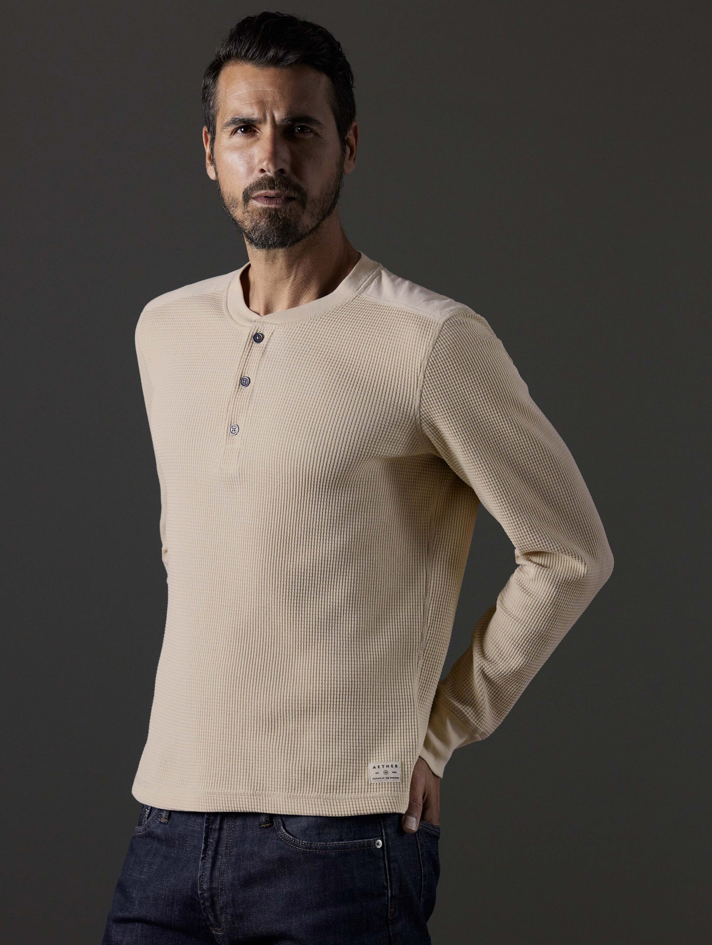 Front 3/4 body view of man wearing Milford Waffle Henley in Bone white from AETHER Apparel.