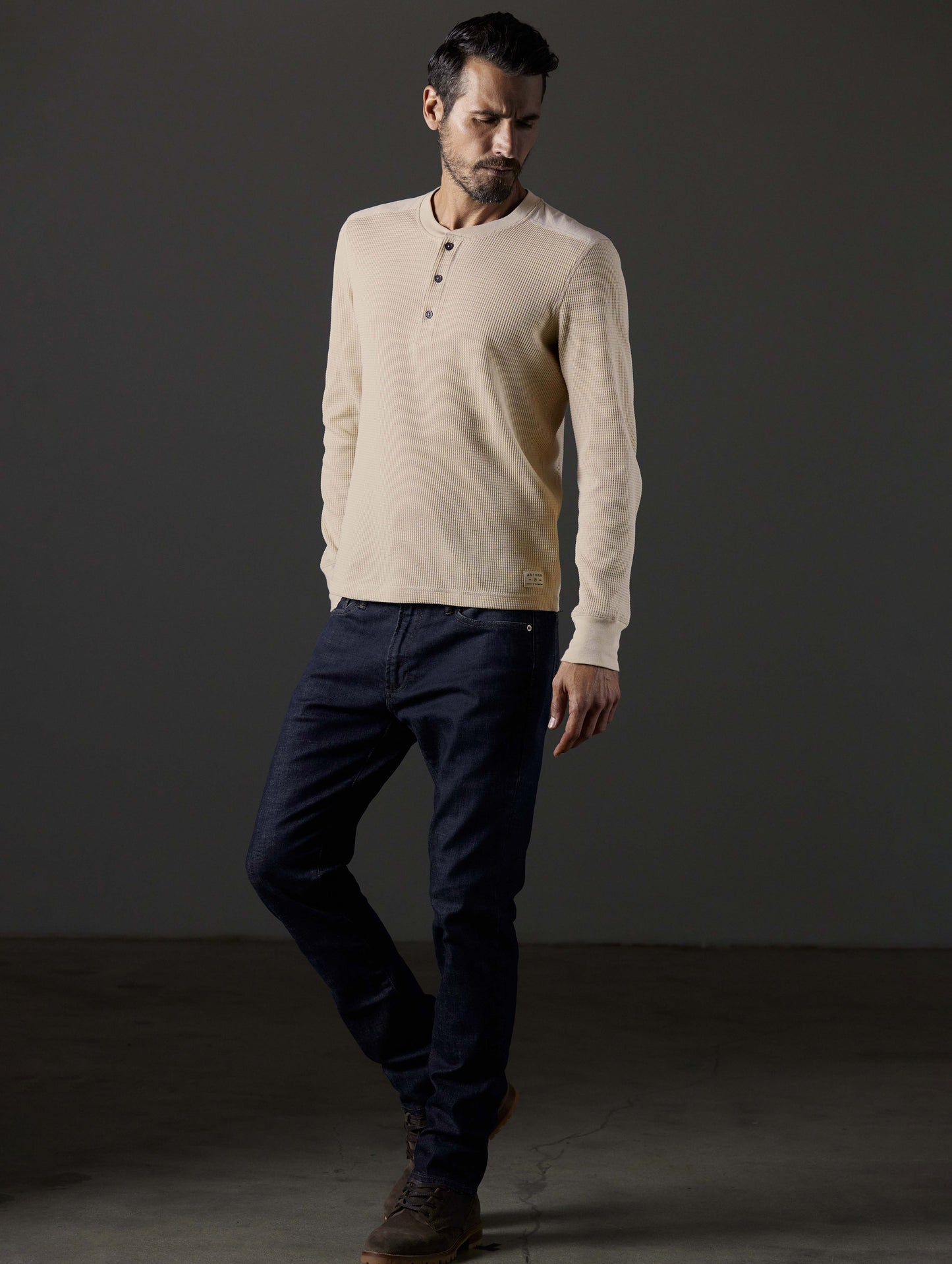 Front 3/4 full-body view of man wearing Milford Waffle Henley in Bone white from AETHER Apparel.