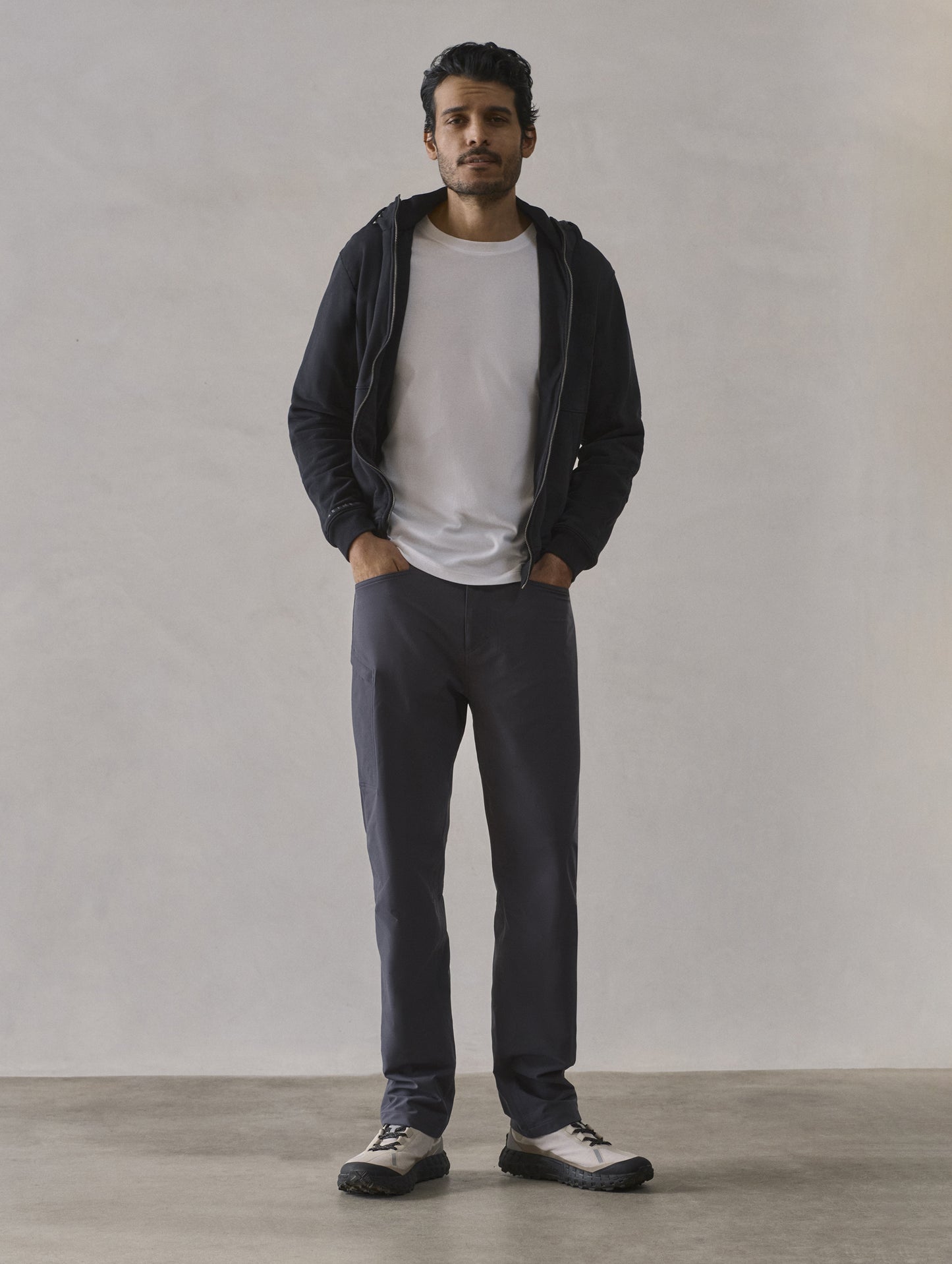 Front full-body view of man wearing Monte Full-Zip Hoodie in Onyx Black from AETHER Apparel.