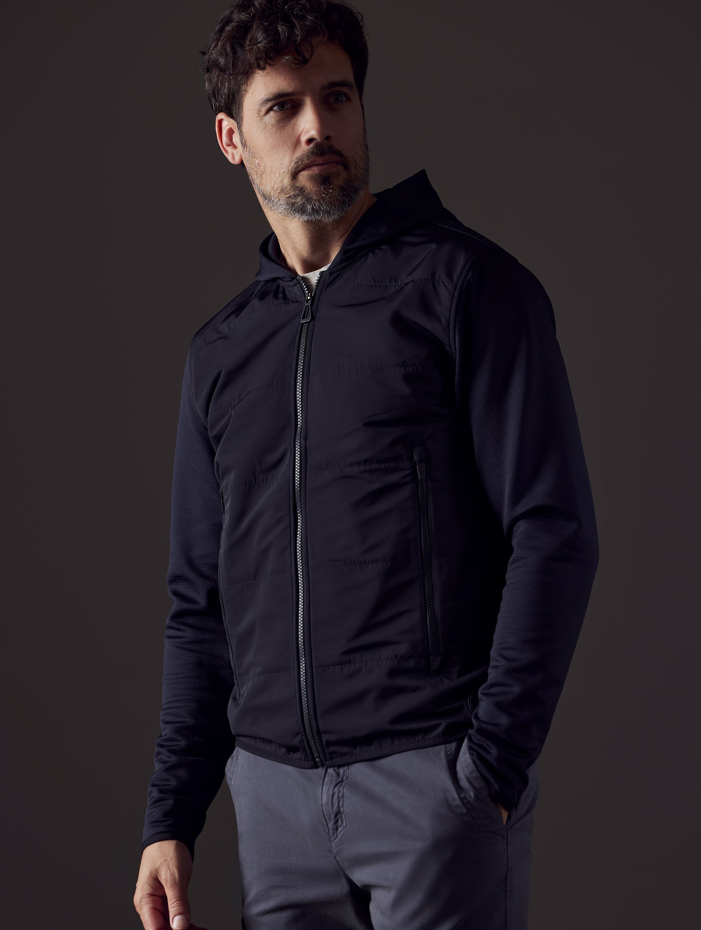 Front 3/4 body view of man wearing Morgan Technical Hoodie in Onyx Black from AETHER Apparel.