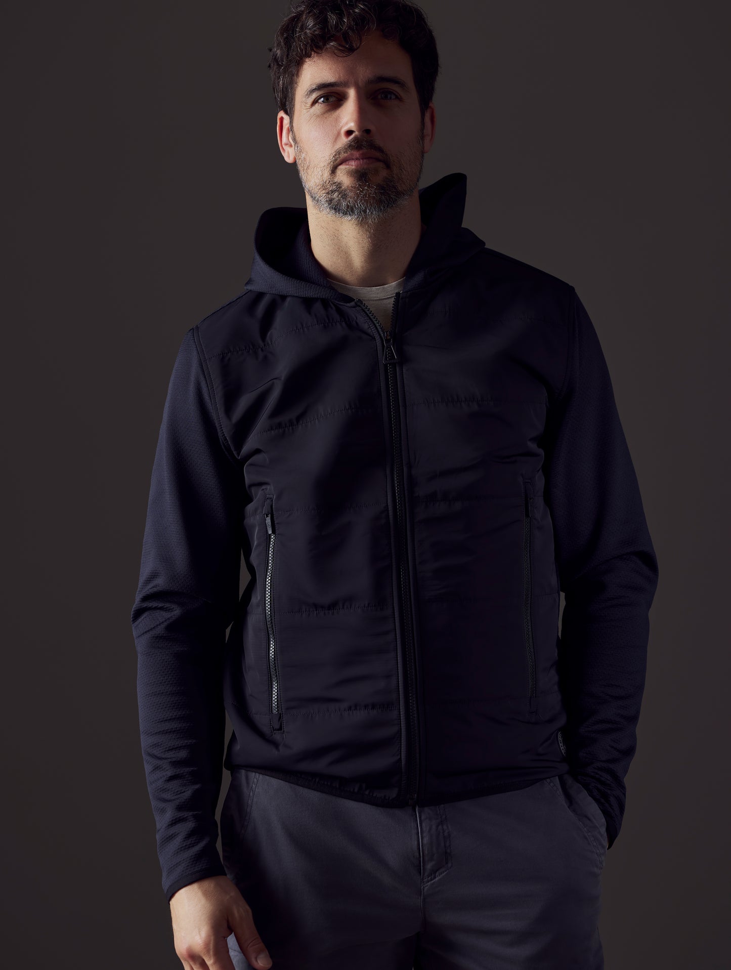 Front body view of man wearing Morgan Technical Hoodie in Onyx Black from AETHER Apparel.