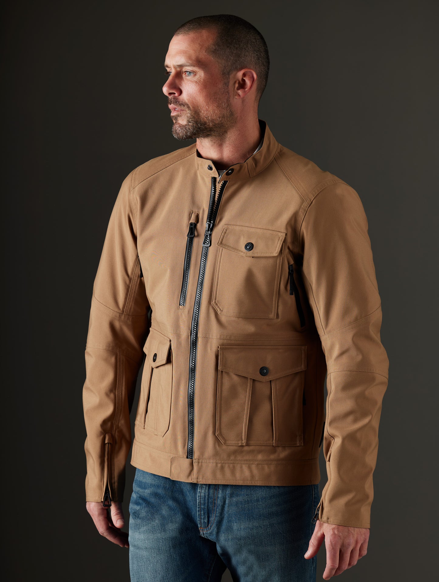 Front 3/4 body view of man wearing Mulholland Motorcycle Jacket in Reverse Brown from AETHER Apparel.