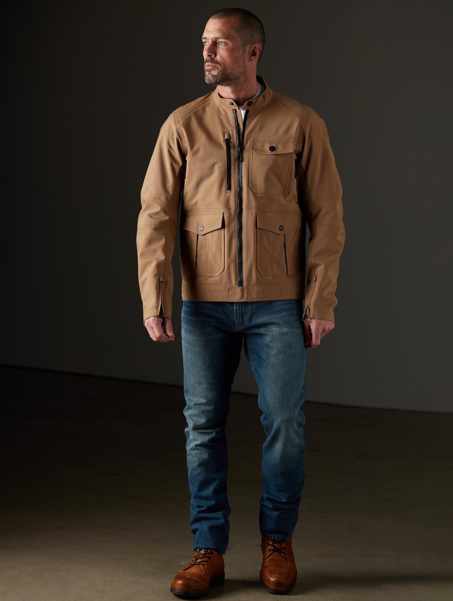 Front full-body view of man wearing Mulholland Motorcycle Jacket in Reverse Brown from AETHER Apparel.