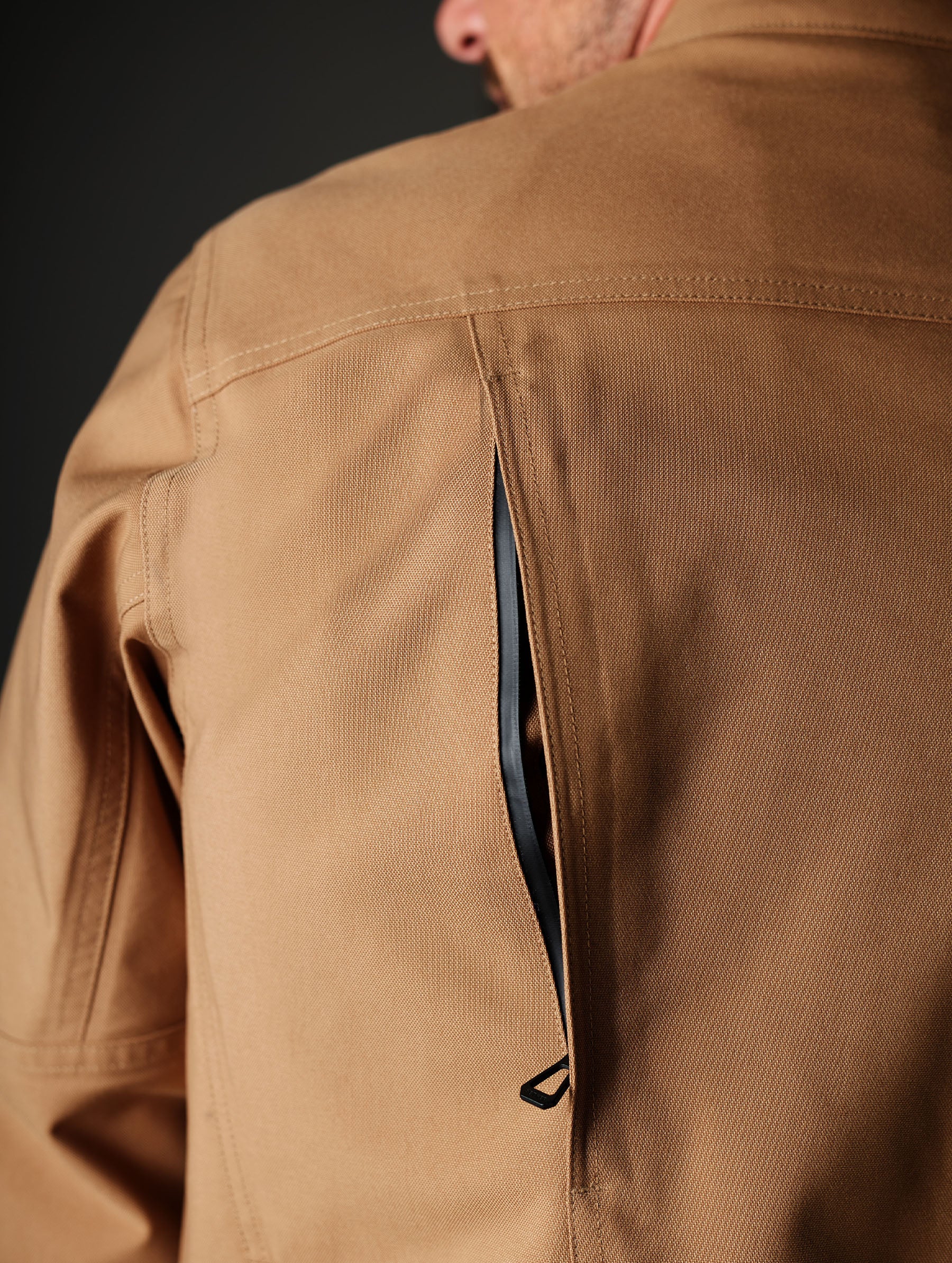Closeup detailed view of the back ventilation exhaust ports on the Mulholland Motorcycle Jacket in Reserve Brown from AETHER Apparel.