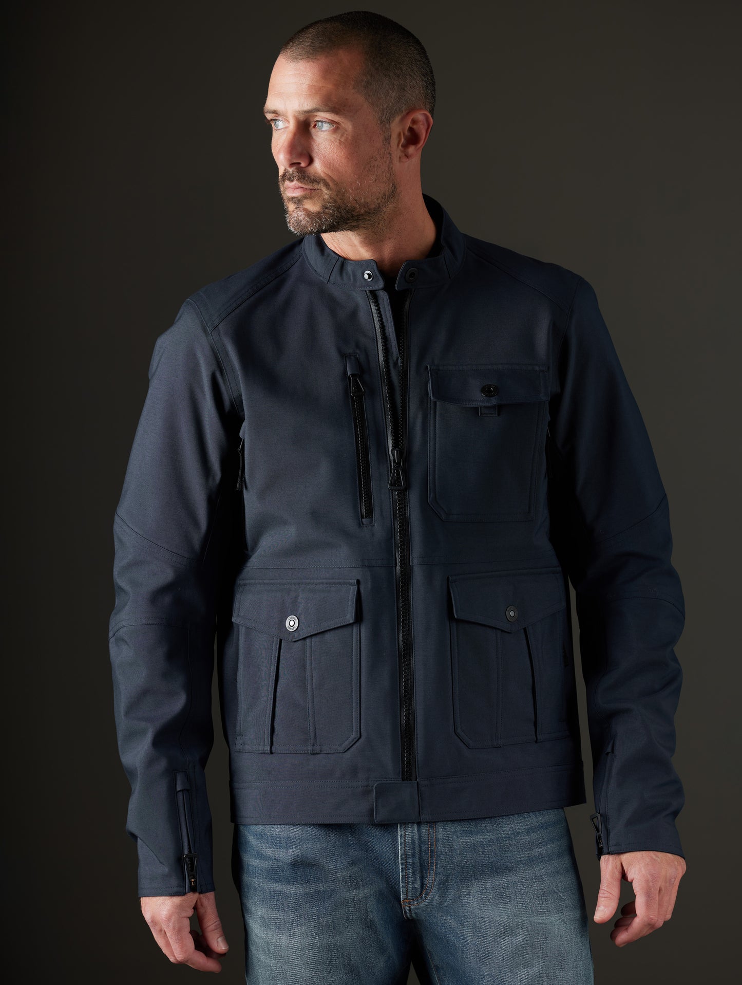 Front body view of man wearing Mulholland Motorcycle Jacket in Total Eclipse dark blue from AETHER Apparel.