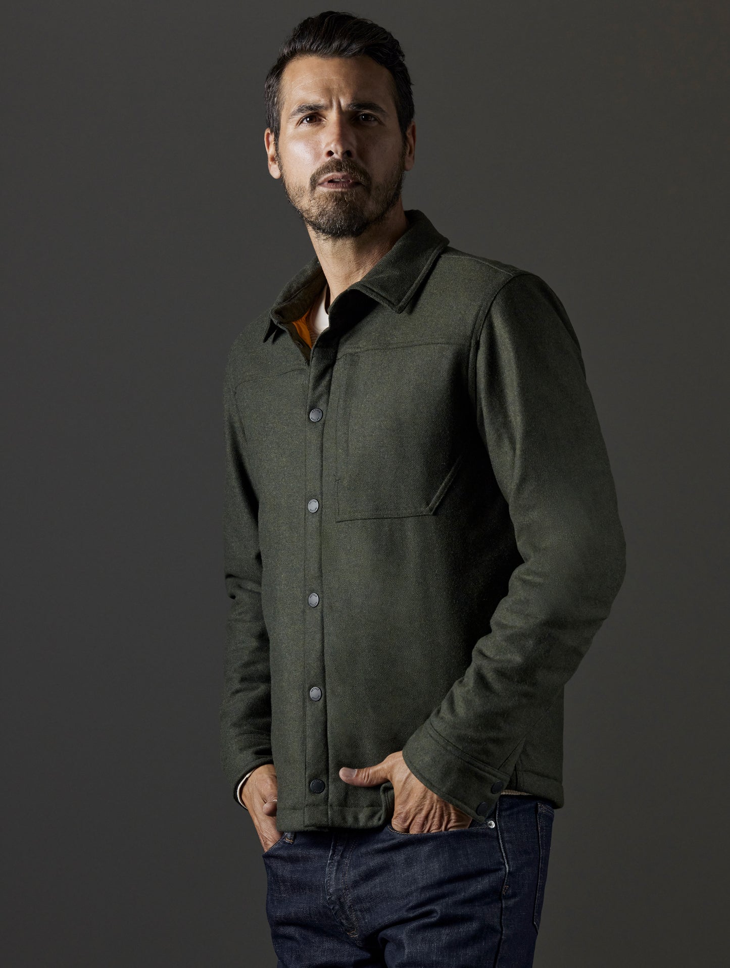 Front 3/4 body view of man wearing Nova Insulated Button-Down in Command Green from AETHER Apparel.