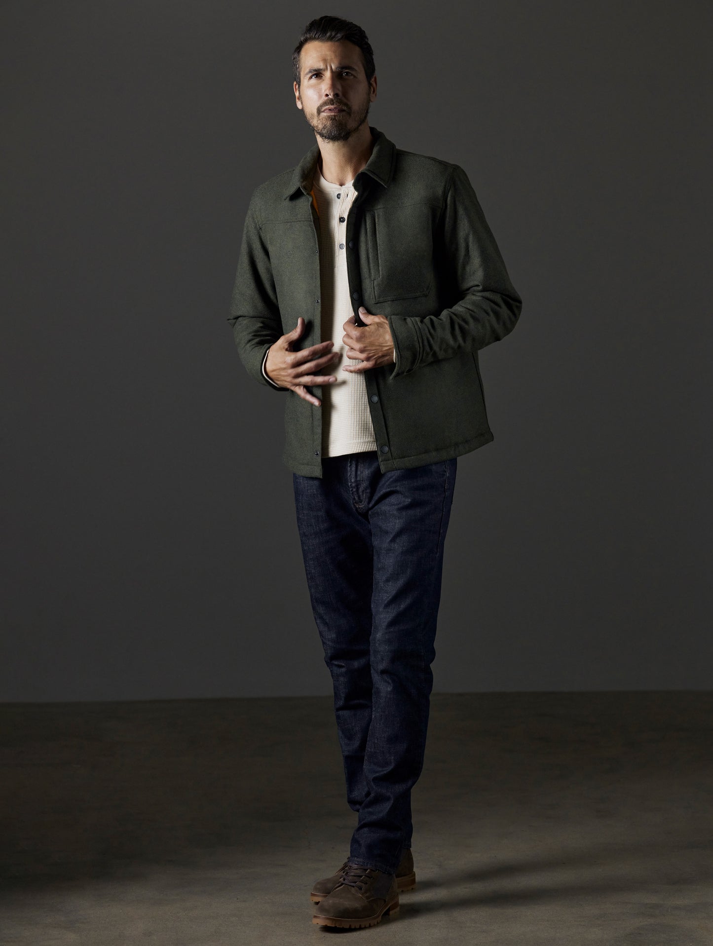 Front 3/4 full-body view of man wearing Nova Insulated Button-Down in Command Green from AETHER Apparel.