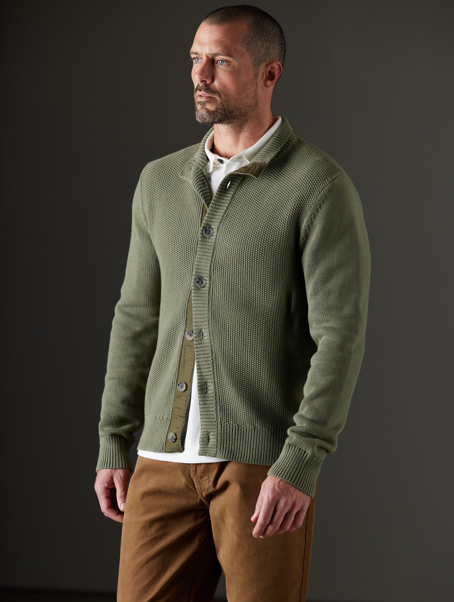 Front 3/4 body view of man wearing Oliver Cotton Button-Up Sweater in Fern Green from AETHER Apparel.