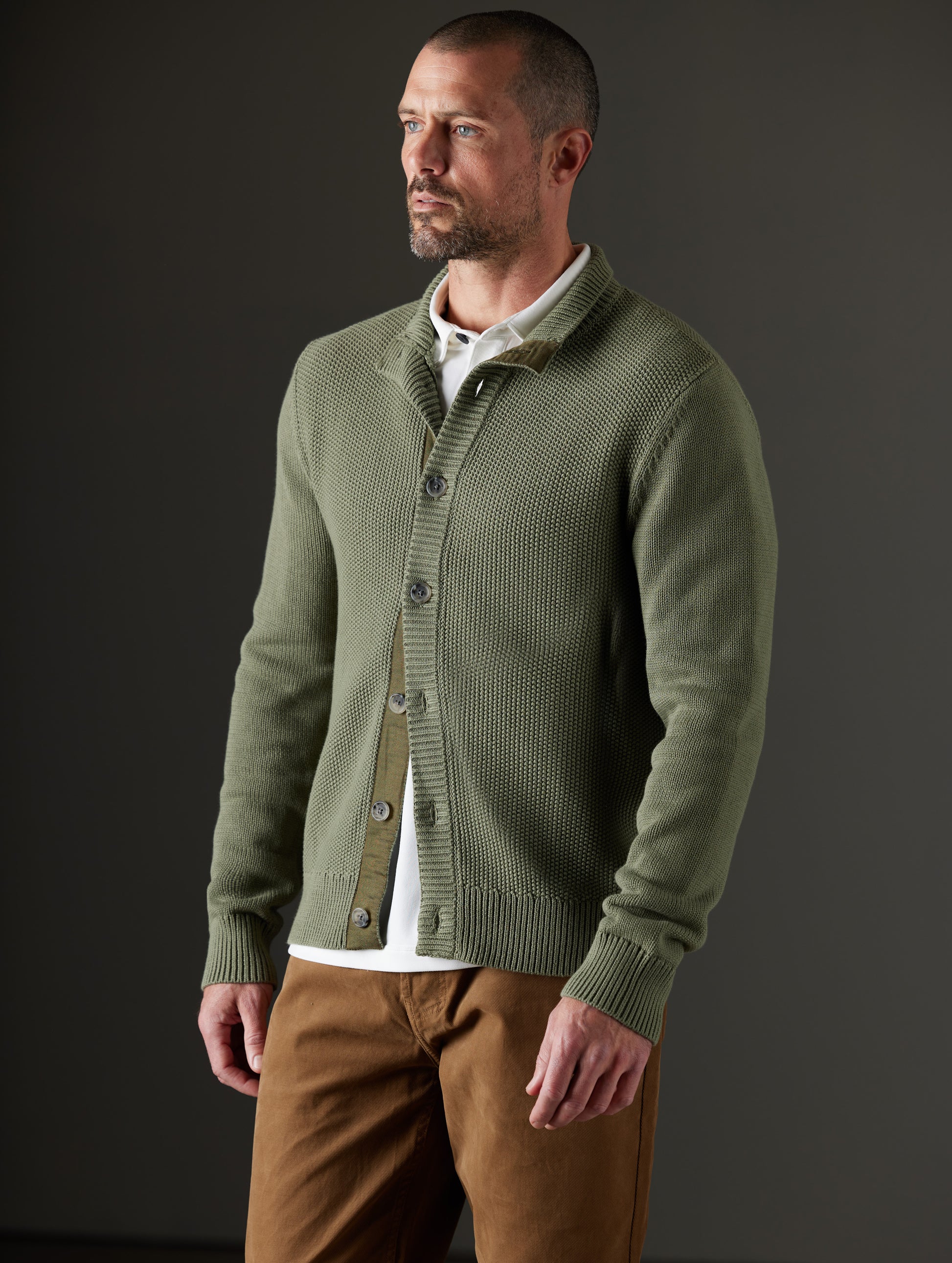 Front 3/4 body view of man wearing Oliver Cotton Button-Up Sweater in Fern Green from AETHER Apparel.