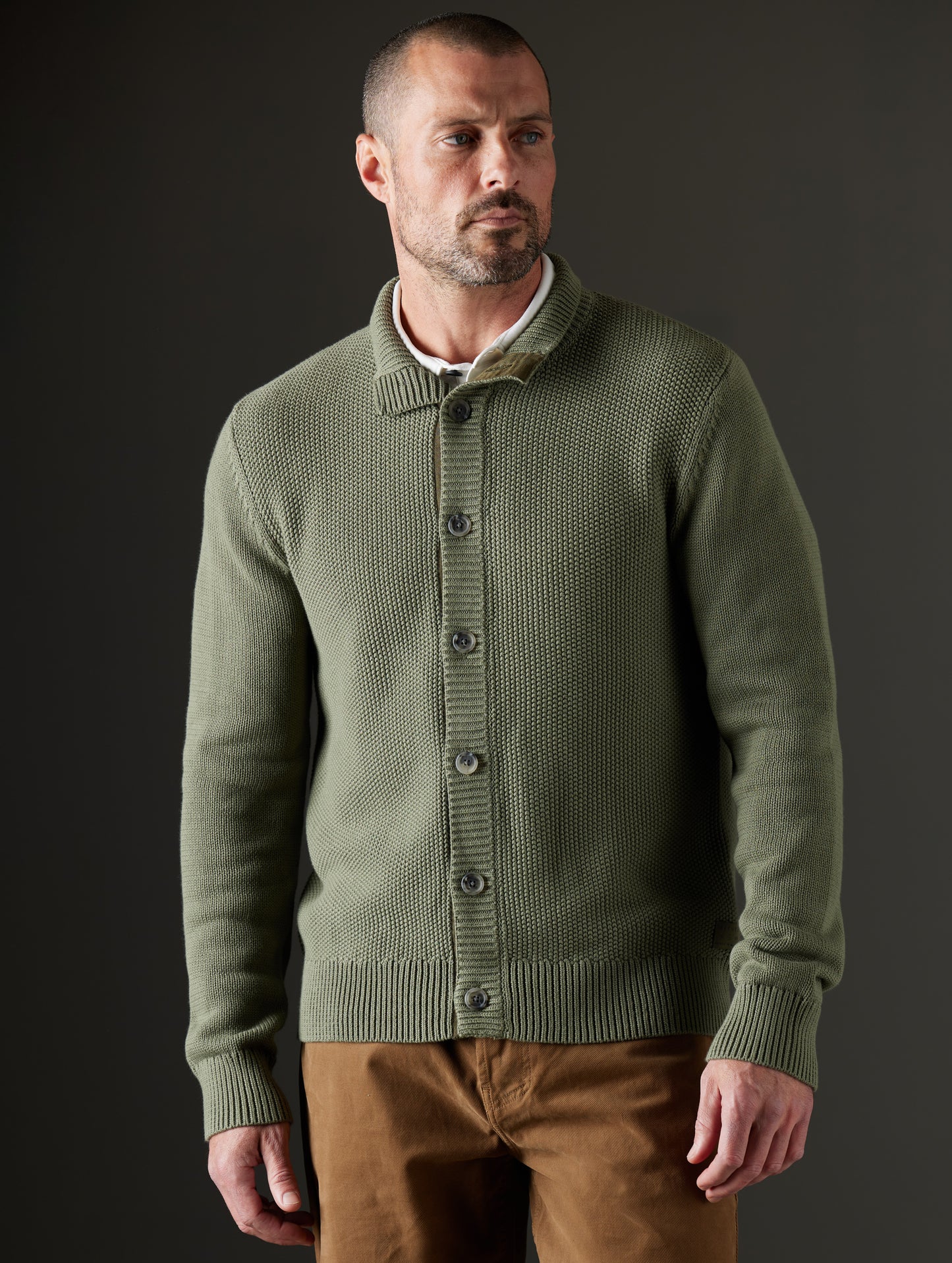 Front body view of man wearing Oliver Cotton Button-Up Sweater in Fern Green from AETHER Apparel.