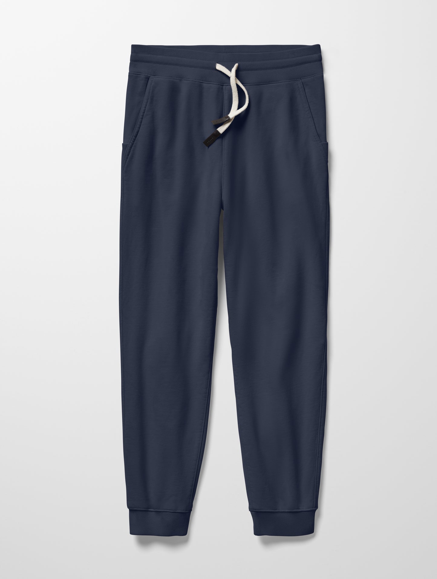 Flat lay of Osa Cuffed Sweatpant in Total Eclipse dark blue from AETHER Apparel.