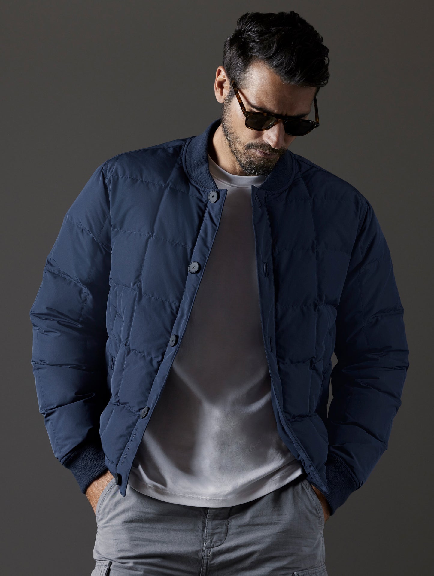 Front body view of man wearing Pacer Jacket in Total Eclipse blue from AETHER Apparel.