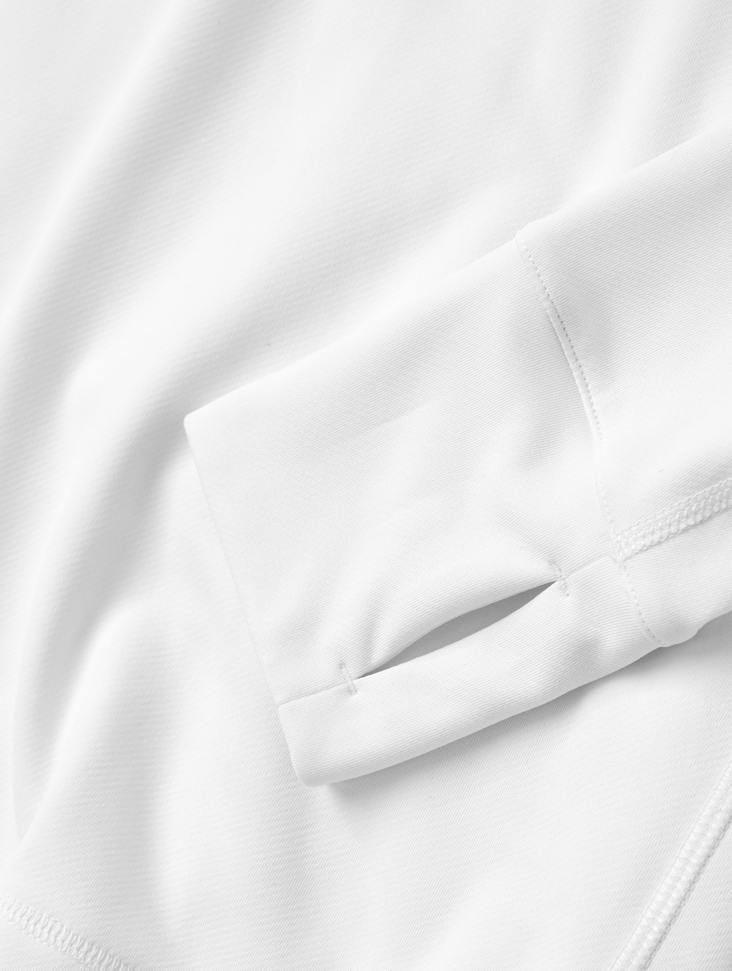 Closeup detailed view of the wrist-cuff thumb-hole on sleeve of the Pacific Hooded Sun Shirt in White from AETHER Apparel.