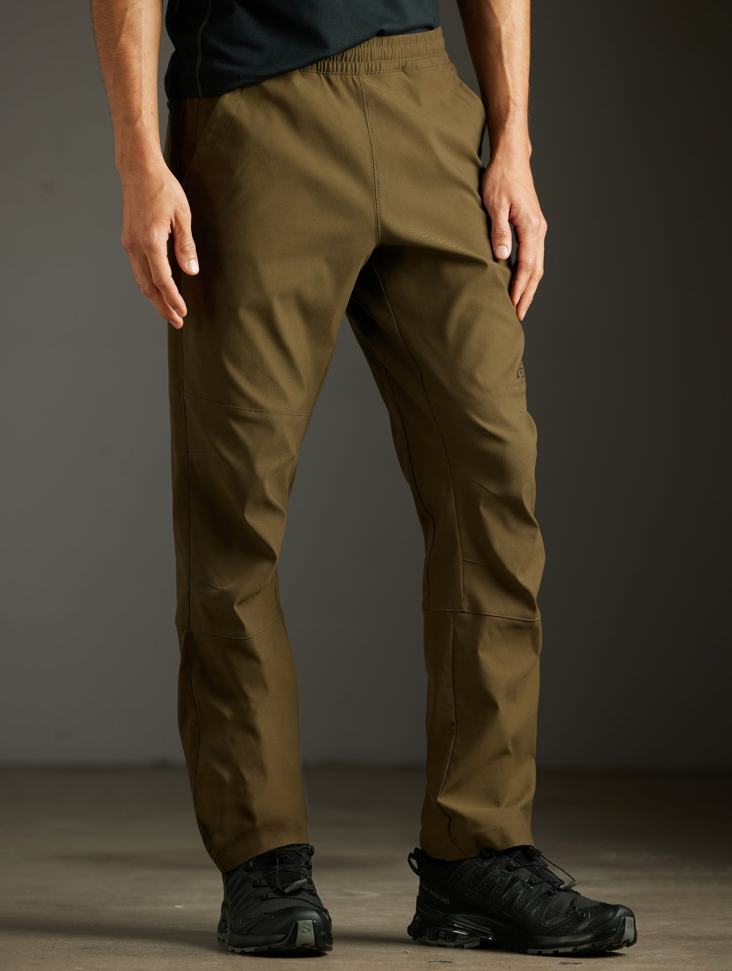 Front 3/4 lower body view of man wearing Perth Pant in Cadet Green from AETHER Apparel.