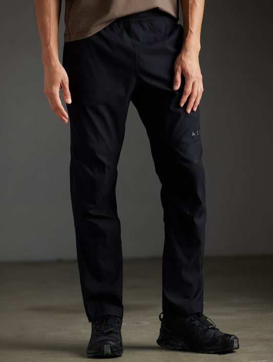 Front lower body view of man wearing Perth Pant in Onyx Black from AETHER Apparel.