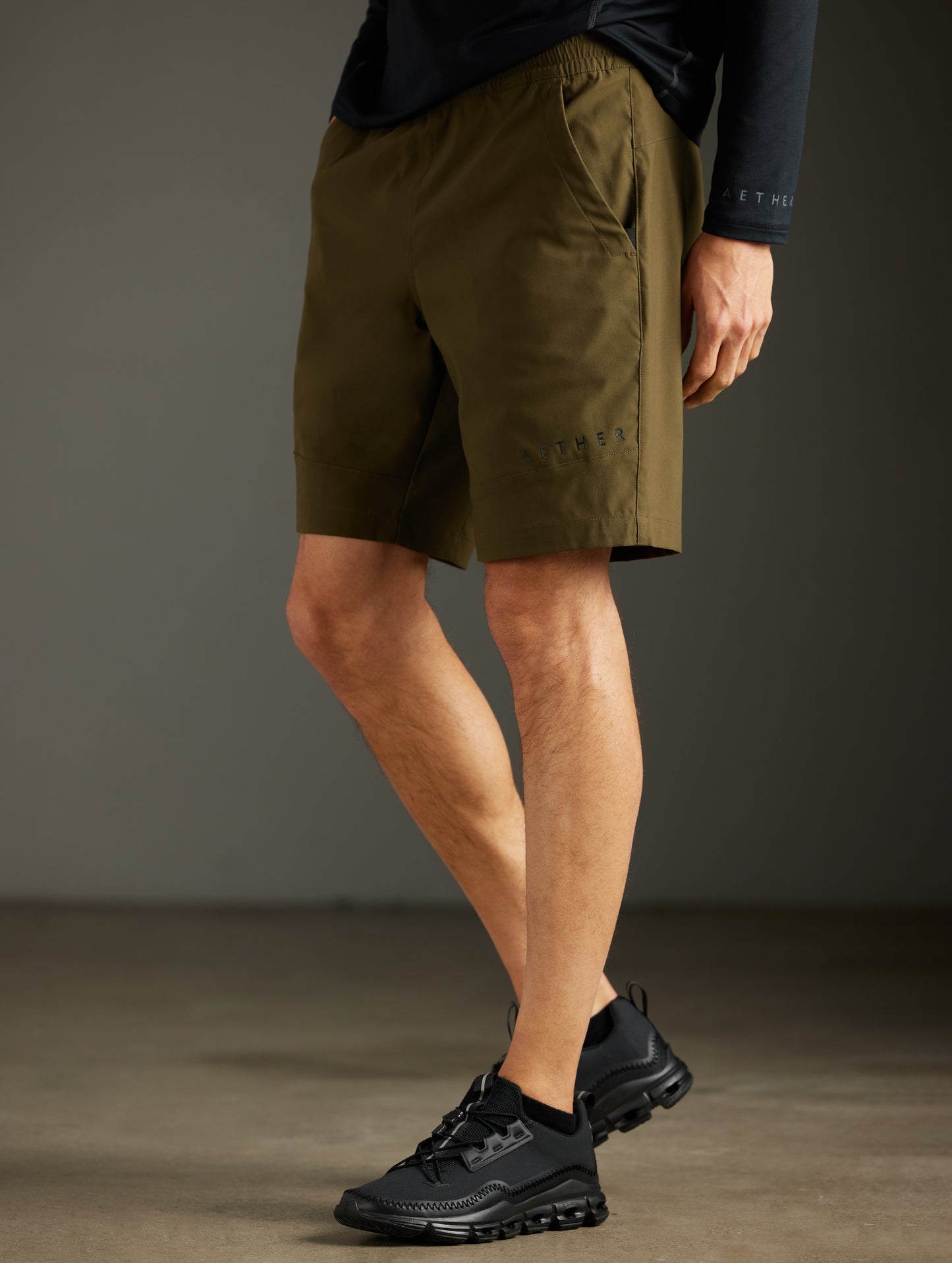 Front 3/4 lower body view of man wearing Perth Short in Cadet Green from AETHER Apparel.