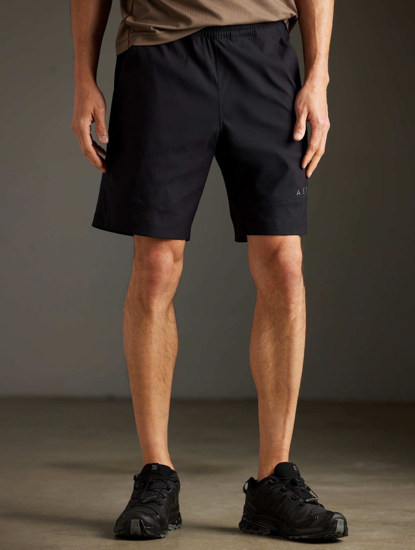 Front lower body view of man wearing Perth Short in Onyx Black from AETHER Apparel.