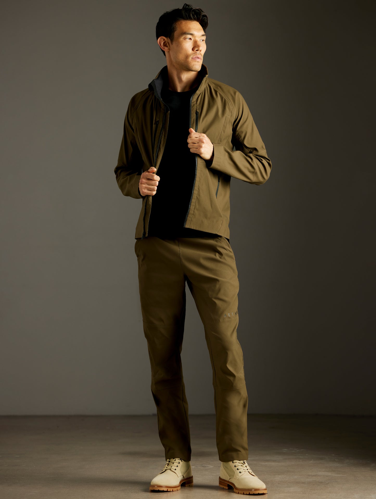Front full-body view of man wearing Perth Vented Jacket and Perth Pant in Cadet Green from AETHER Apparel.