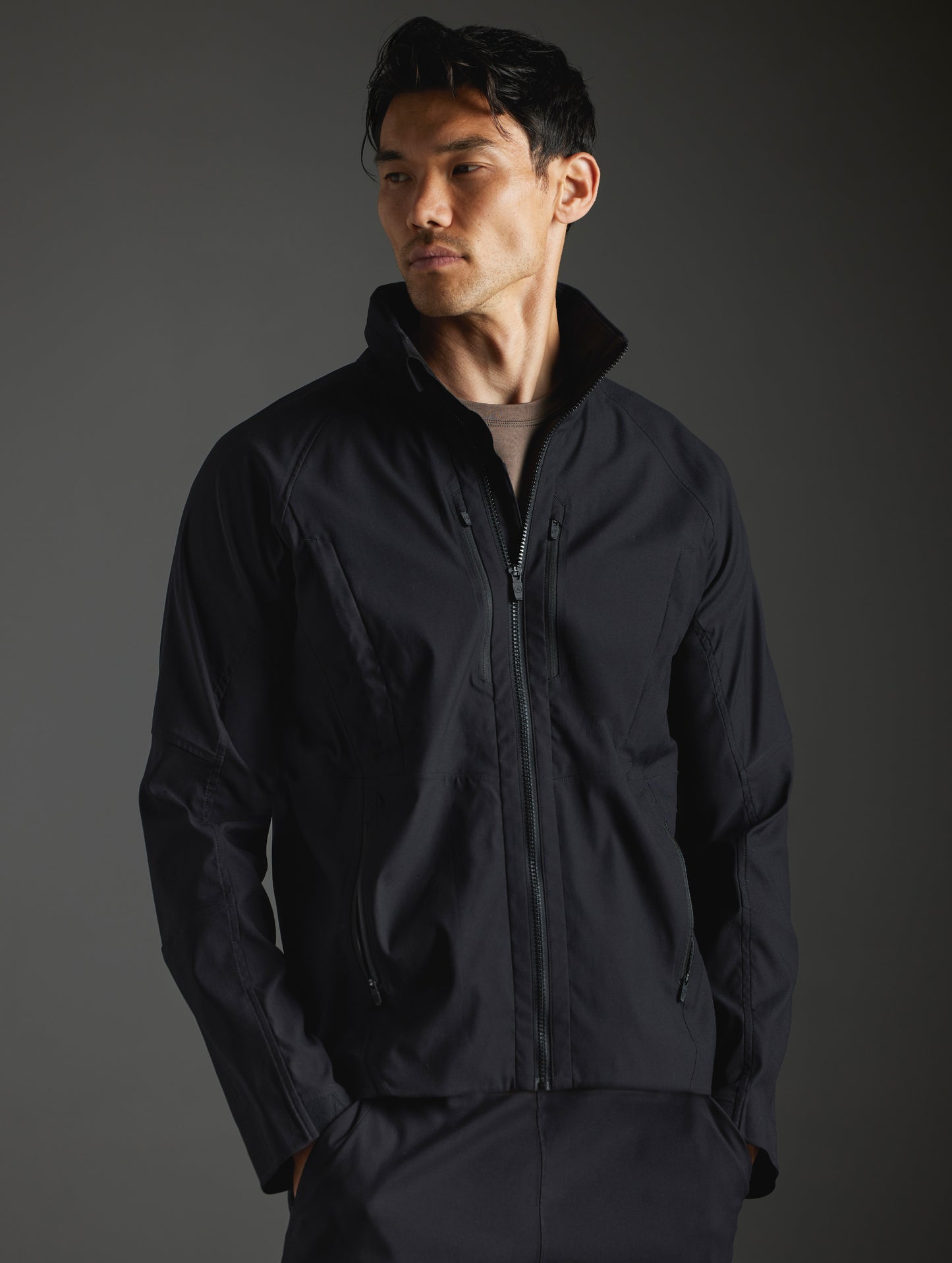 Front body view of man wearing Perth Vented Jacket in Onyx Black from AETHER Apparel.