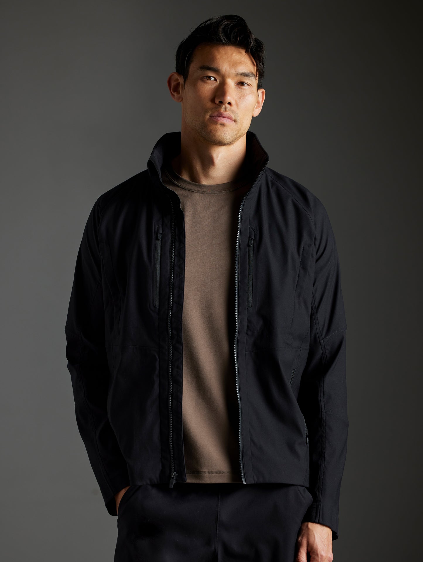 Front body view of man wearing Perth Vented Jacket in Onyx Black from AETHER Apparel.