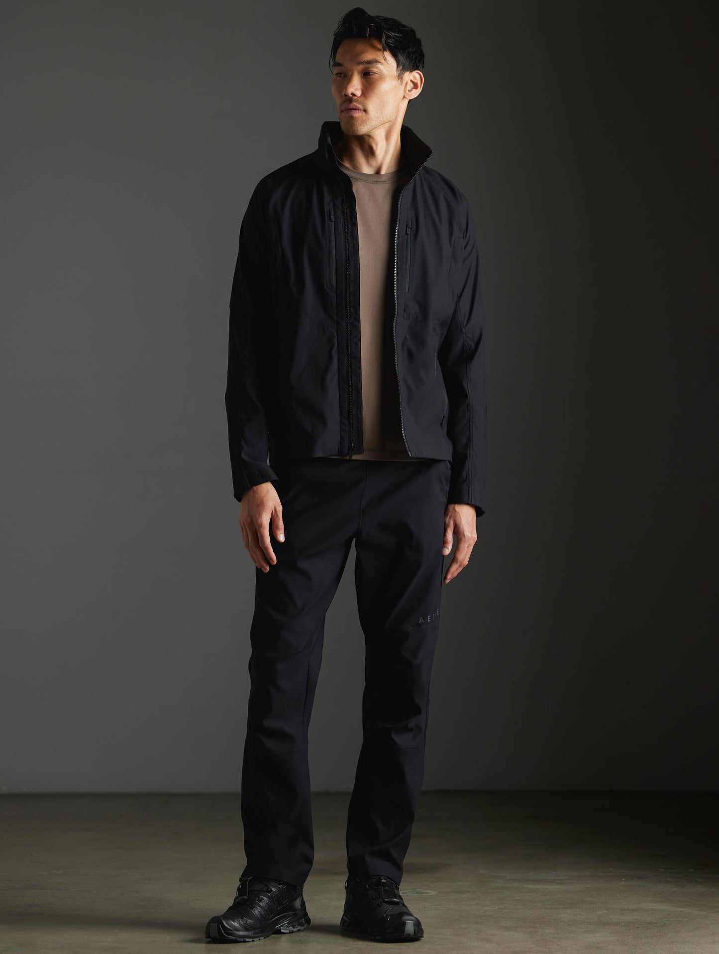 Front full-body view of man wearing Perth Vented Jacket and Perth Pant in Onyx Black from AETHER Apparel.