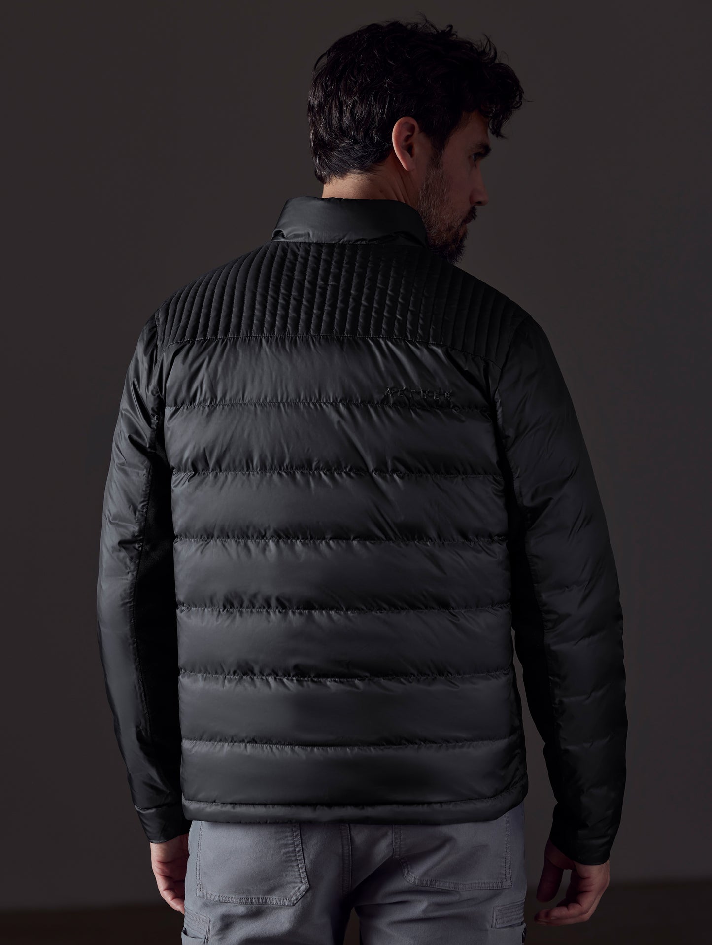 man wearing a black insulated jacket from AETHER Apparel