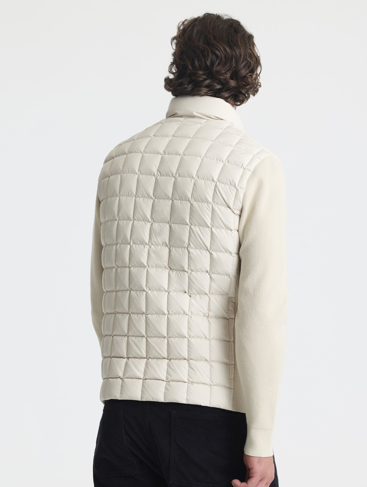 Rear, angled upper-body view of man wearing M Phase Full-Zip in Bone white from AETHER Apparel.
