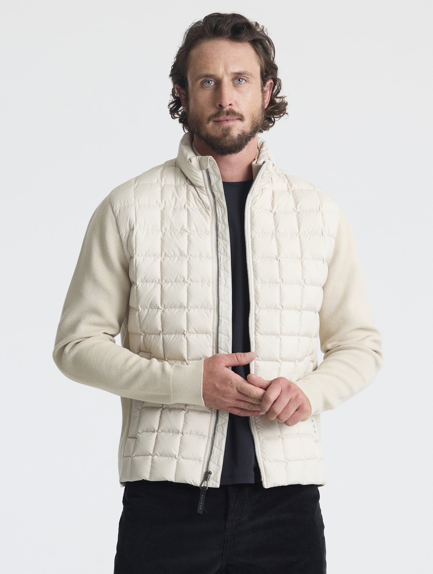 Front upper-body view of man wearing unzipped M Phase Full-Zip in Bone white from AETHER Apparel.