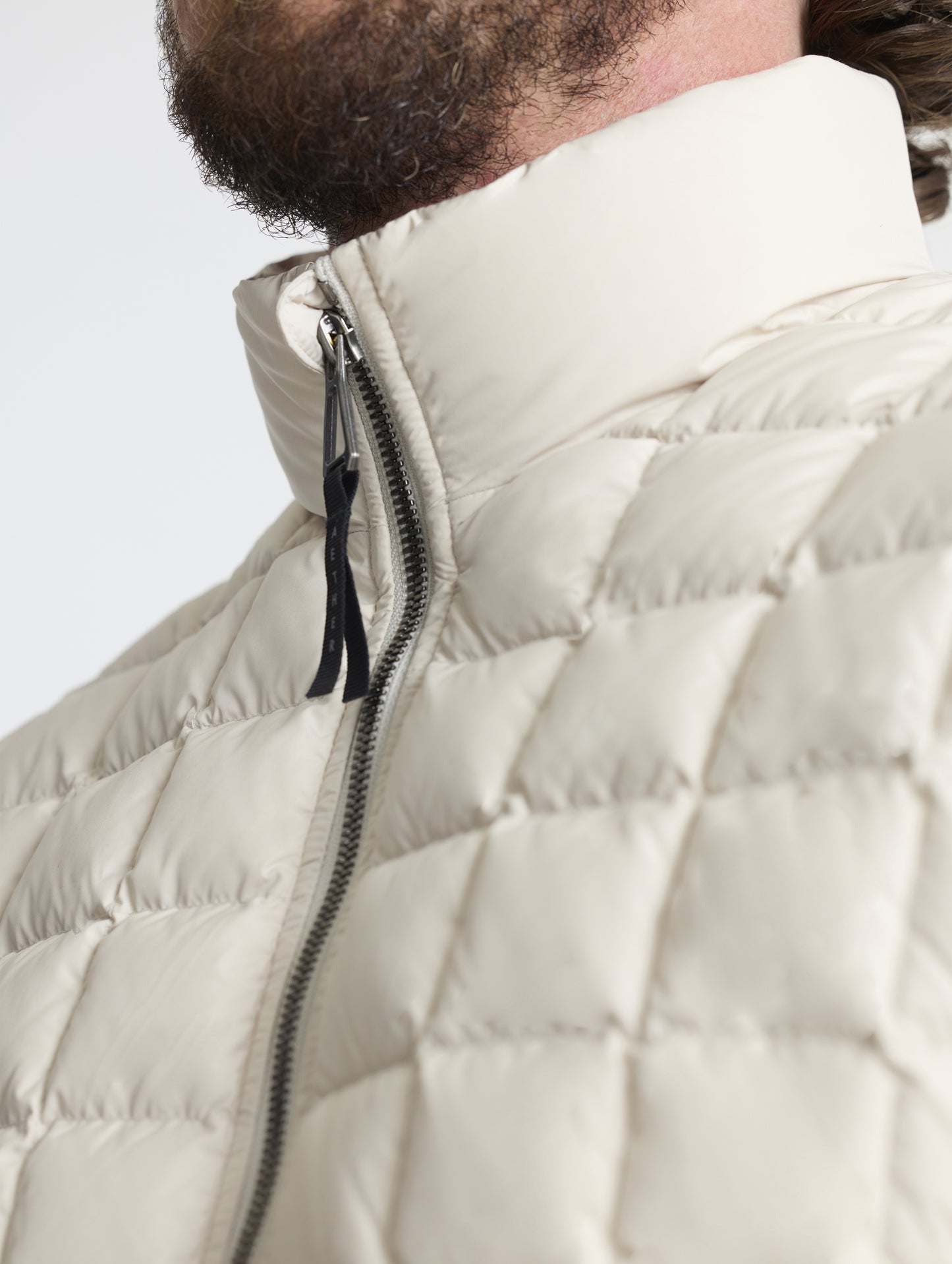 Closeup detailed view of the quilted body and insulated collar on the M Phase Full-Zip in Bone white from AETHER Apparel.