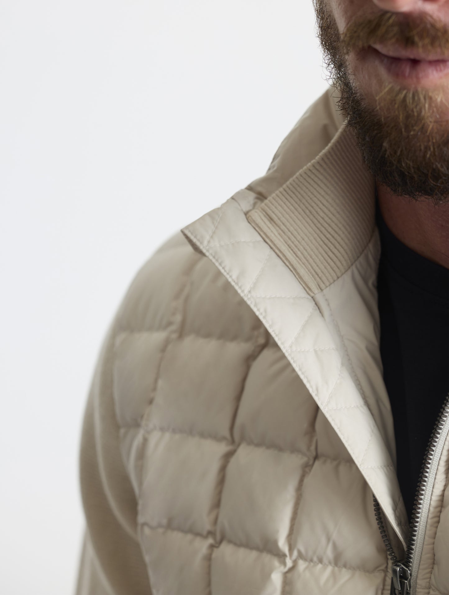 Closeup detailed view of the cotton-and-cashmere blend 2x2 rib knit interior collar on the M Phase Full-Zip in Bone white from AETHER Apparel.