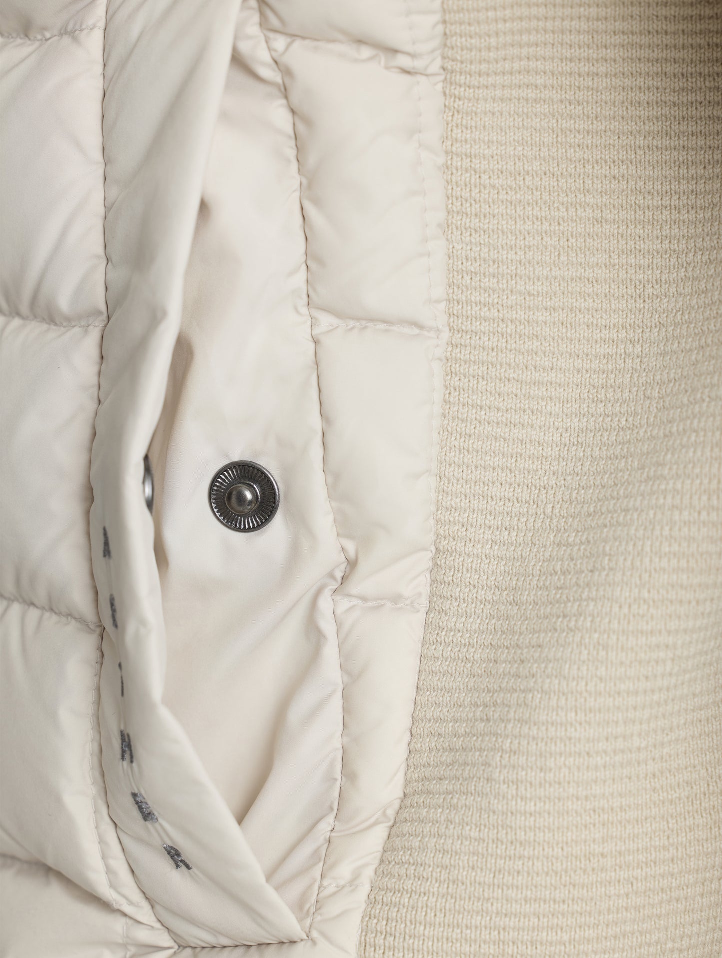 Closeup detailed view of the snap-secured welt hand pocket on the M Phase Full-Zip in Bone white from AETHER Apparel.