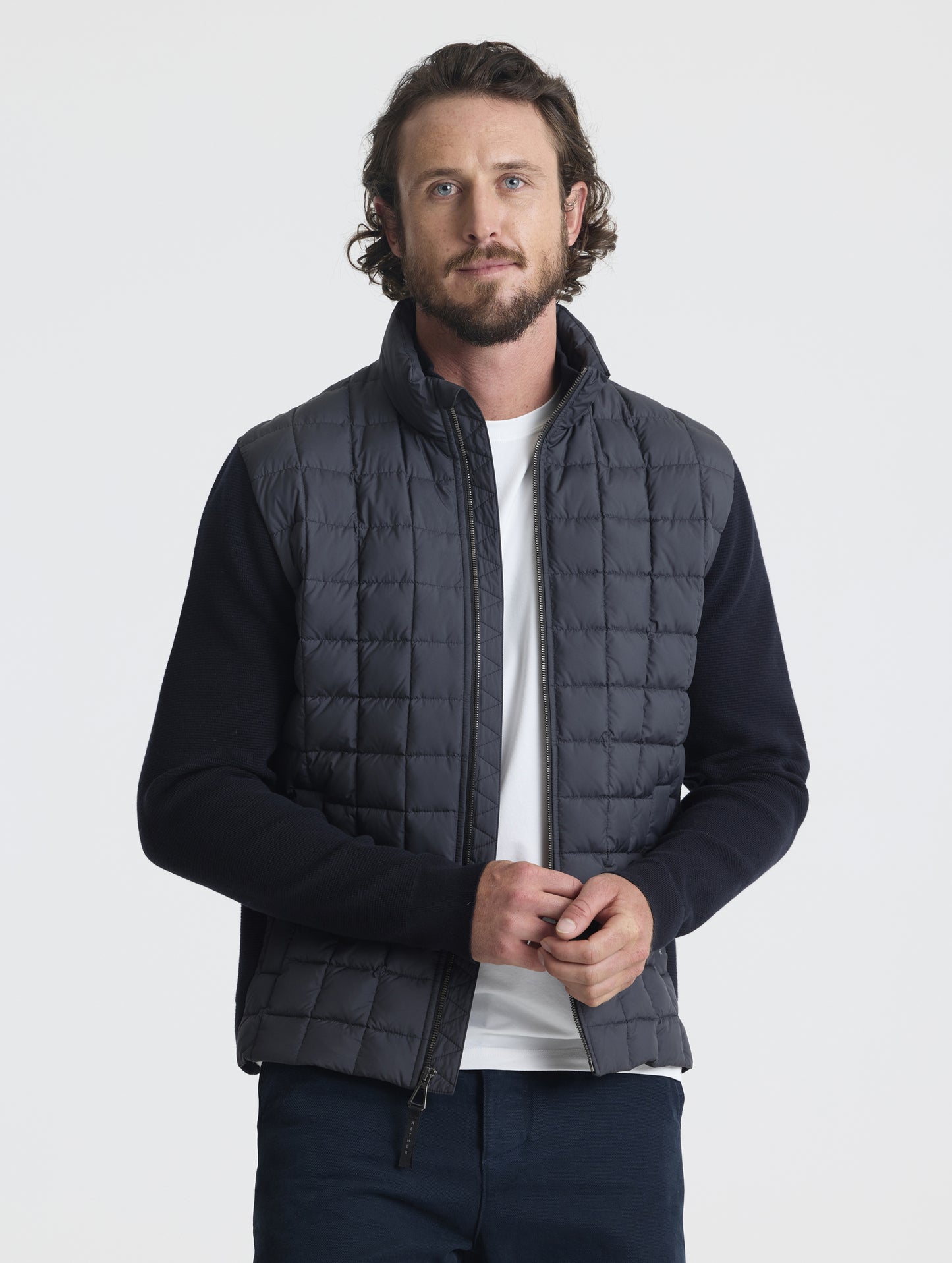 Front, upper-body view of man wearing unzipped M Phase Full-Zip in Onyx Black from AETHER Apparel.
