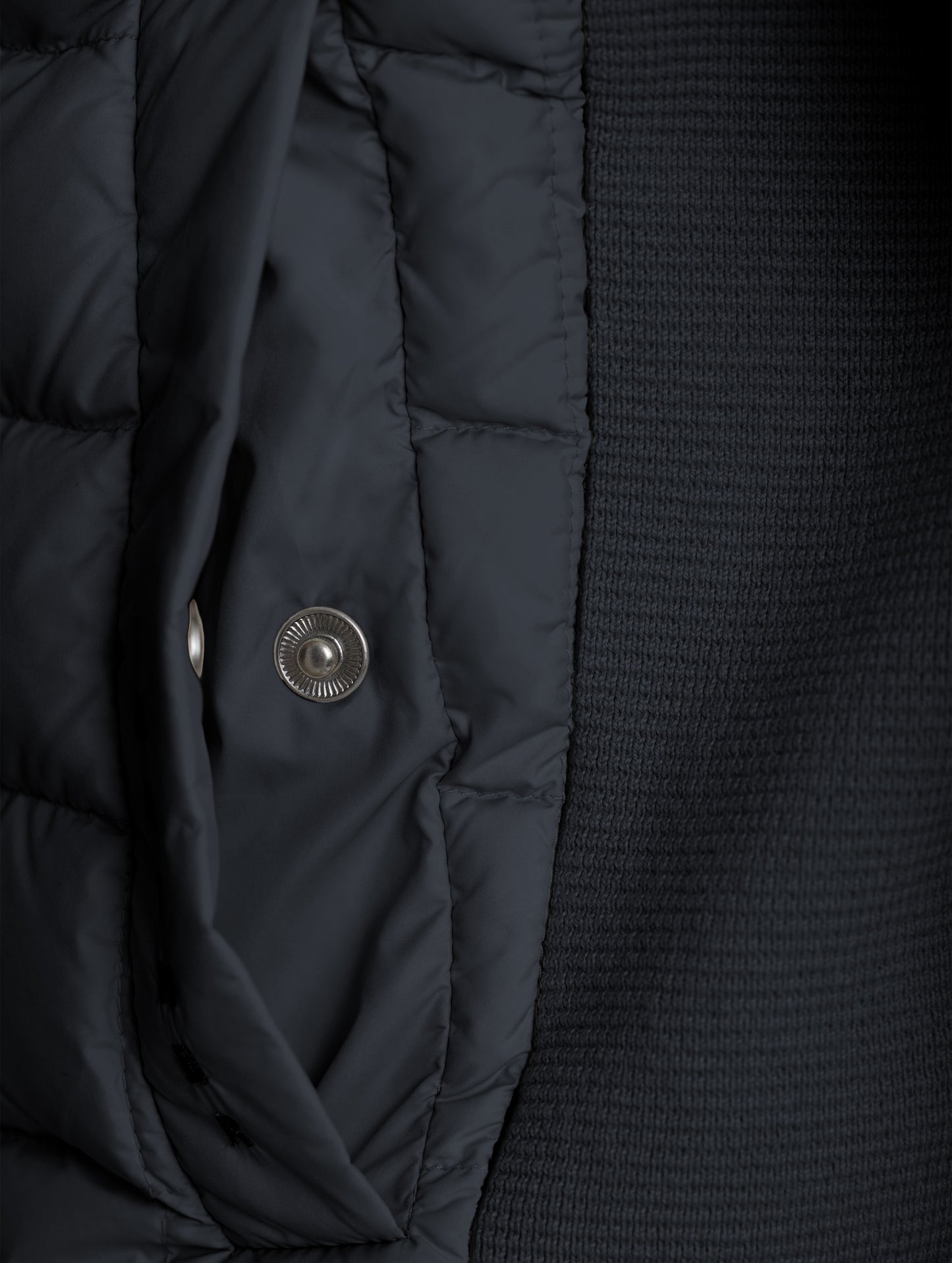Closeup detailed view of the snap-secured welt hand pocket on the M Phase Full-Zip in Onyx Black from AETHER Apparel.