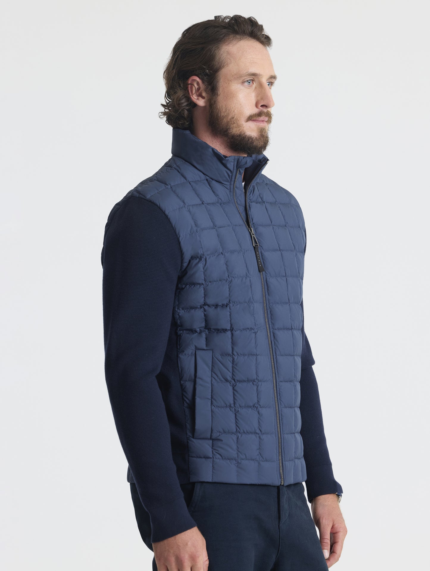 Front, angled upper-body view of man wearing M Phase Full-Zip in Total Eclipse dark blue from AETHER Apparel.