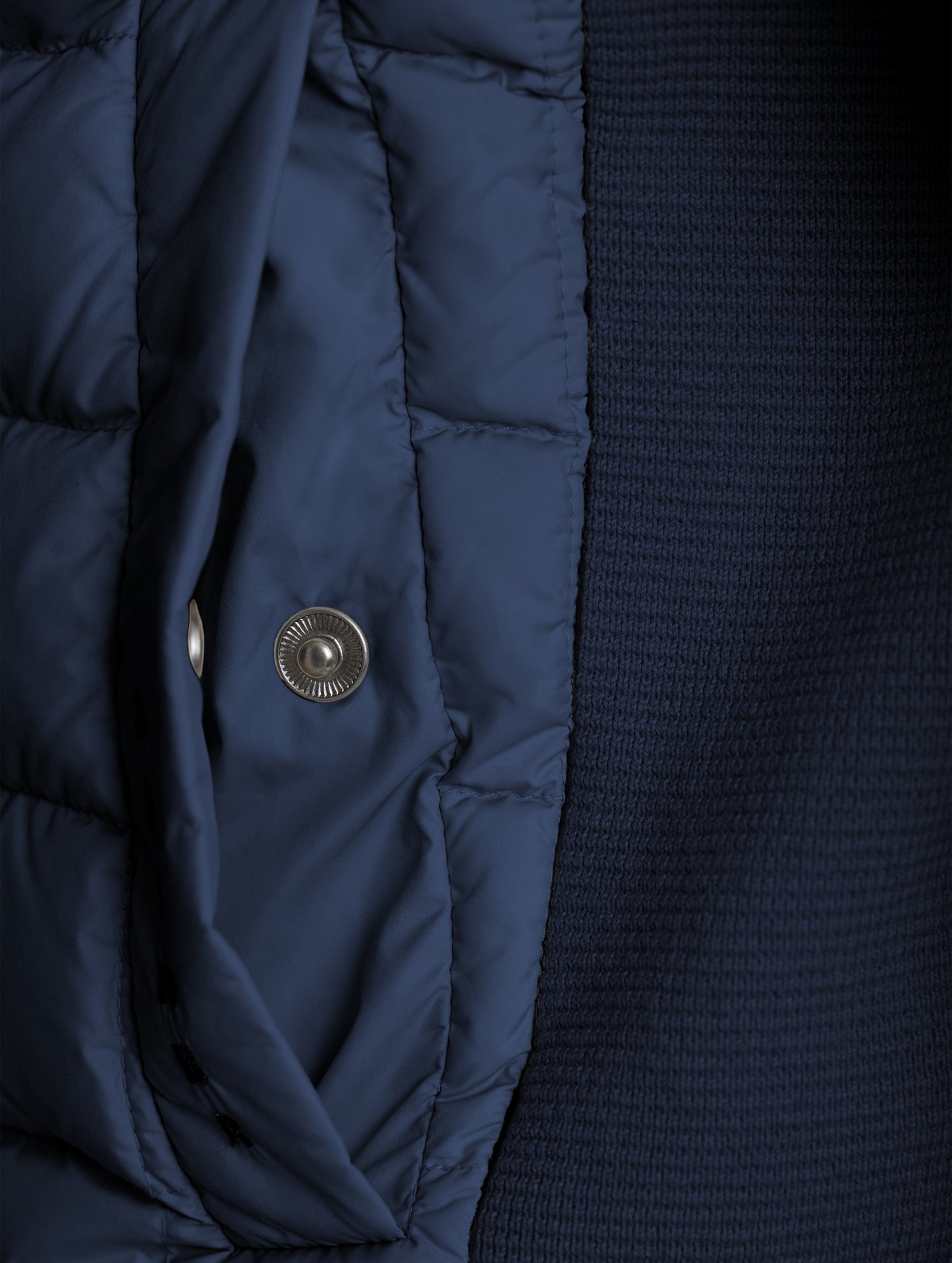 Closeup detailed view of the snap-secured welt hand pocket on the M Phase Full-Zip in Total Eclipse dark blue from AETHER Apparel.