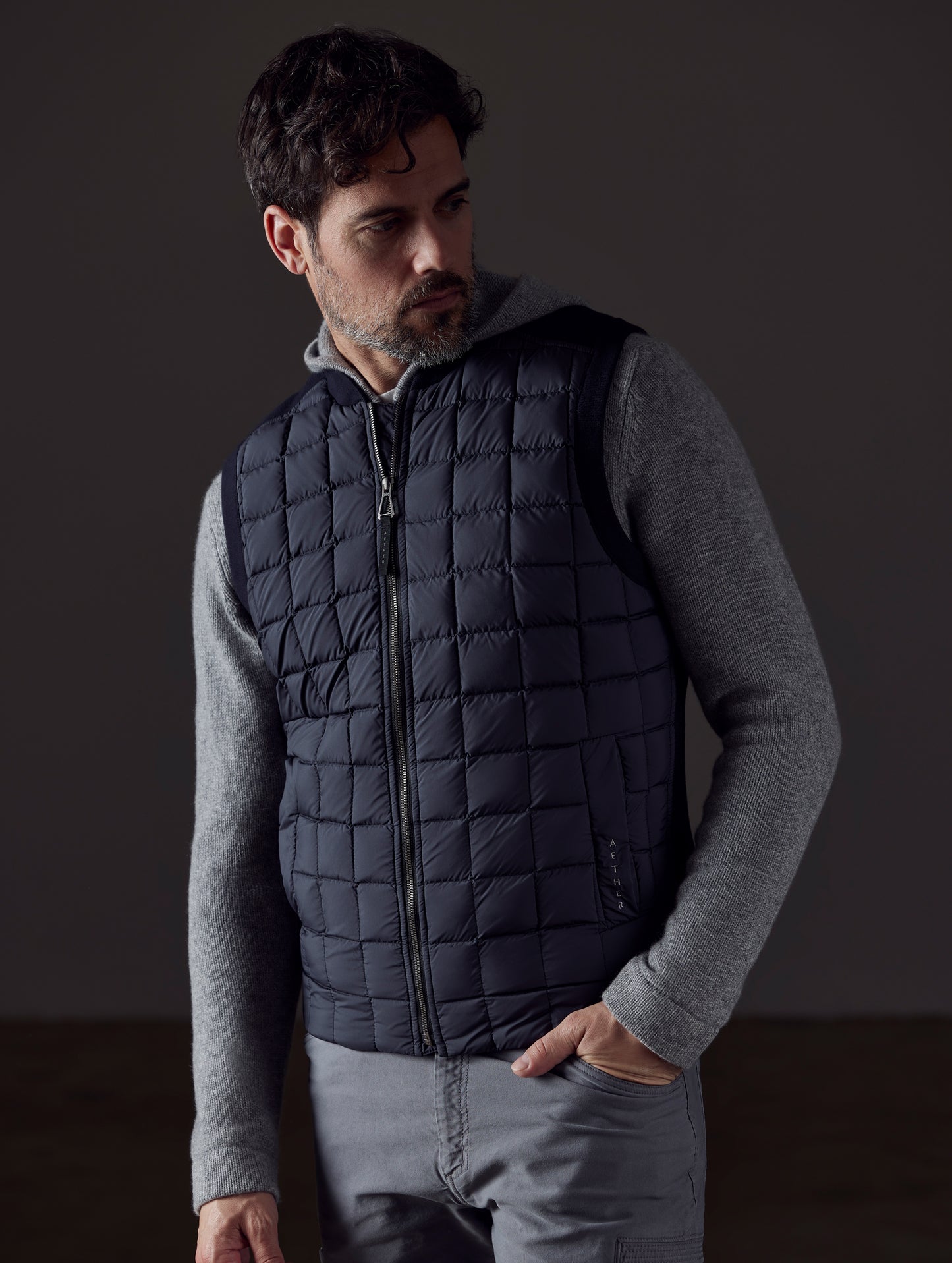Front body view of man wearing Phase Vest in Onyx Black from AETHER Apparel.