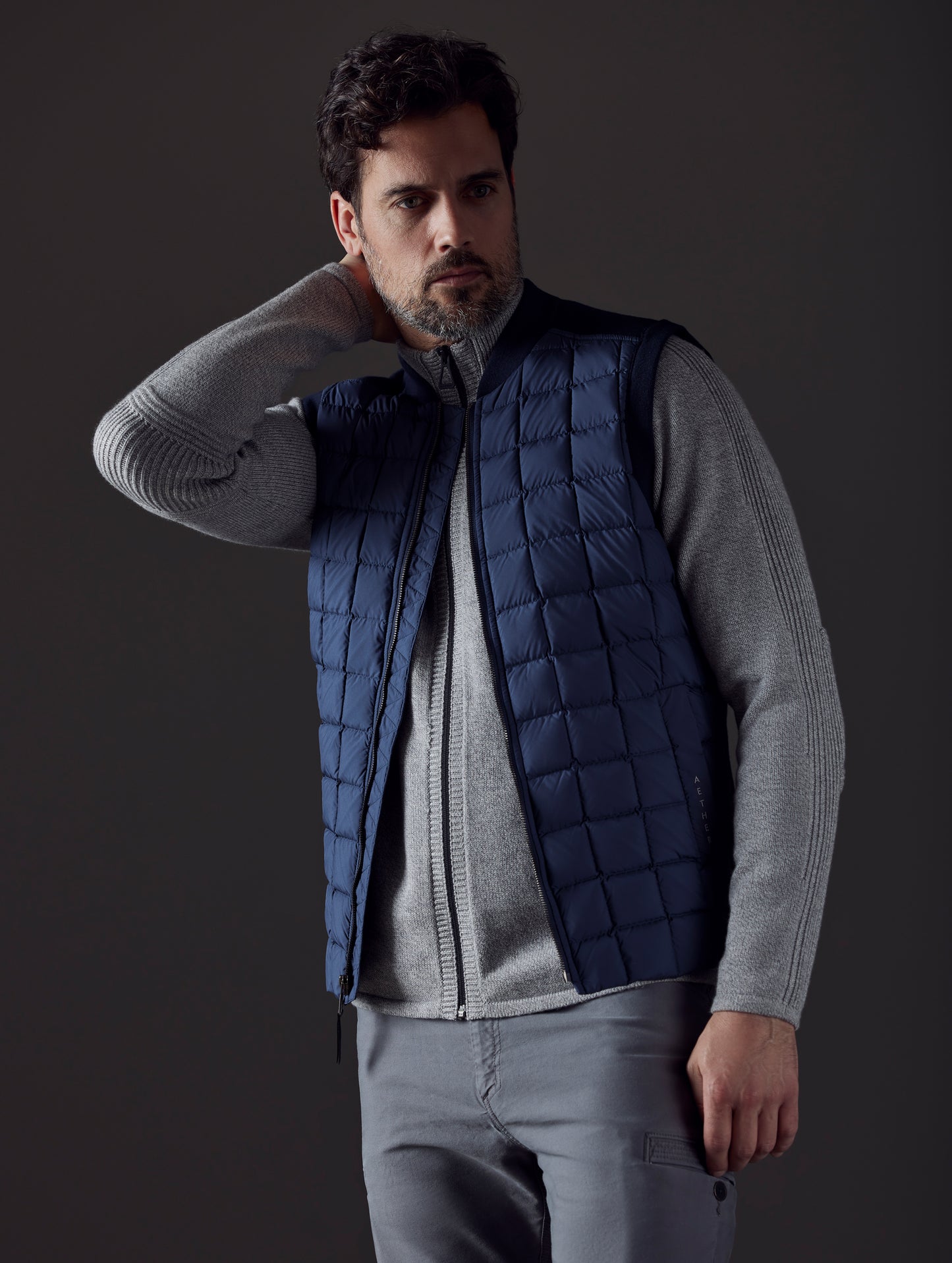 Front body view of man wearing Phase Vest in Total Eclipse dark blue from AETHER Apparel.