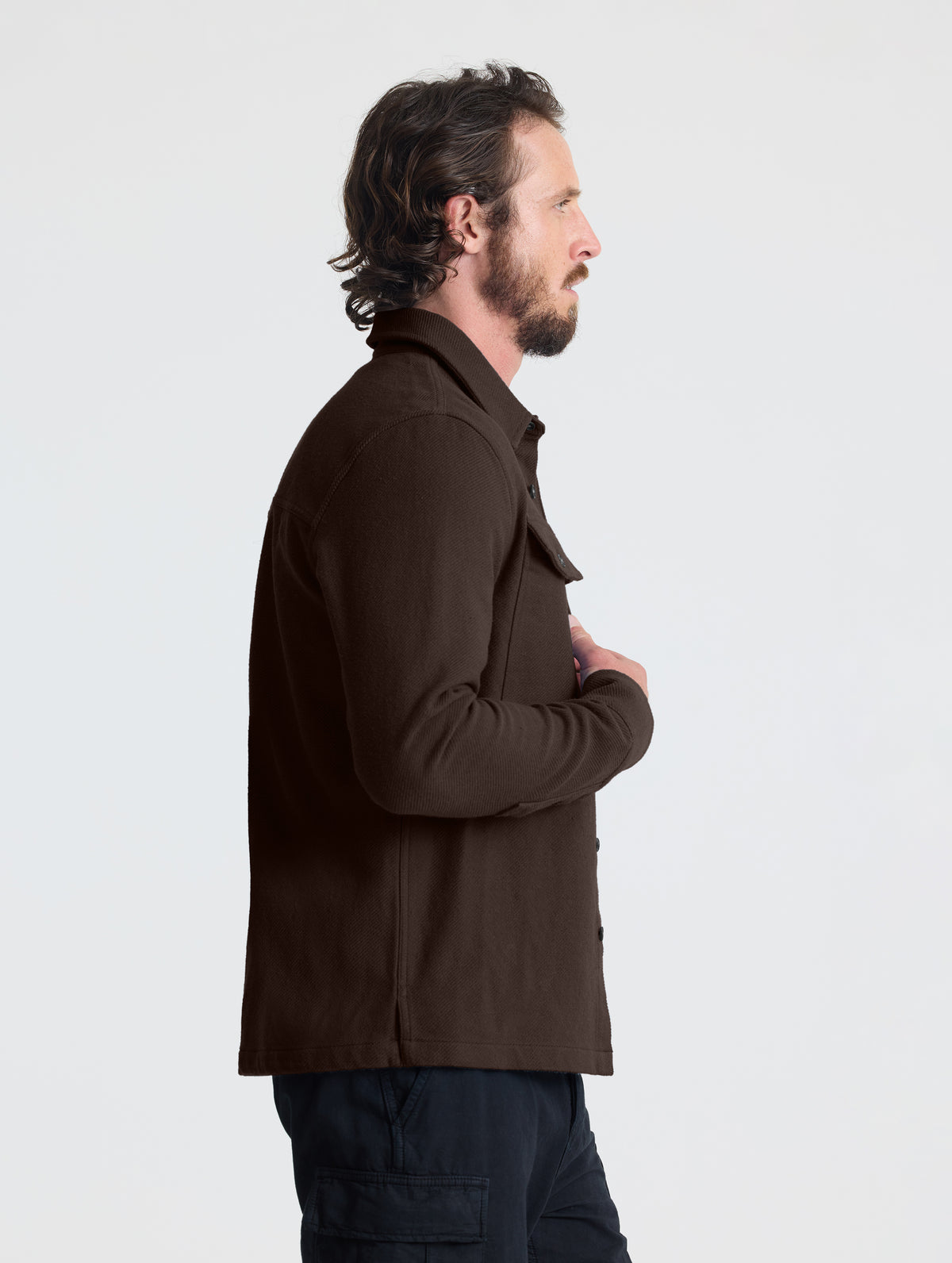Side profile upper-body view of man wearing the Pioneer Heavyweight Button-Down in Ash Brown from AETHER Apparel.
