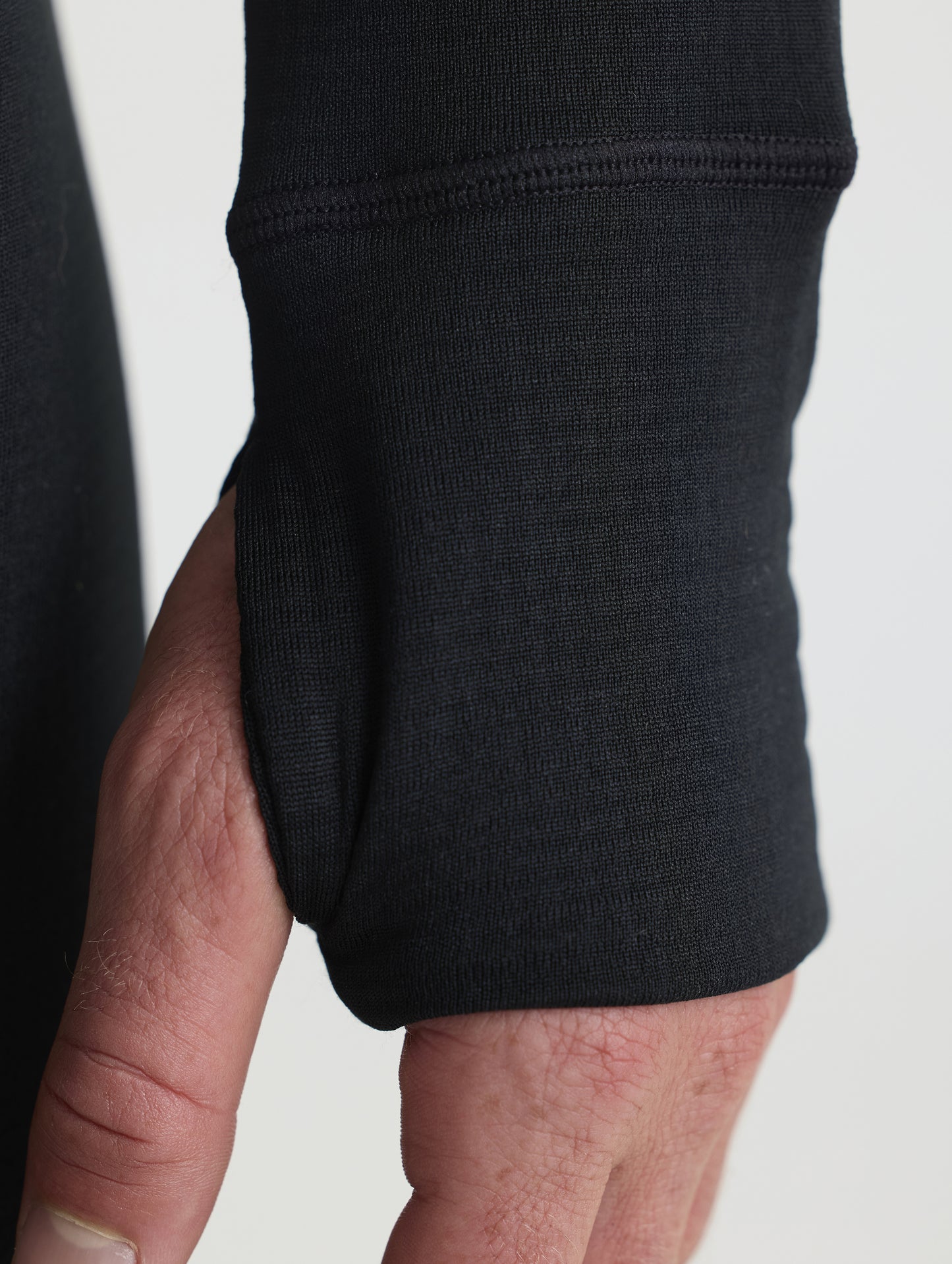 Closeup detailed view of the thumb holes on the Polar Base Layer Crew in Onyx Black from AETHER Apparel.