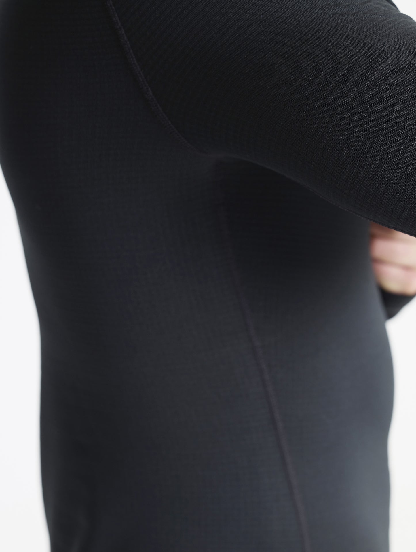 Closeup detailed view of the flat-lock seams on the Polar Base Layer Crew in Onyx Black from AETHER Apparel.