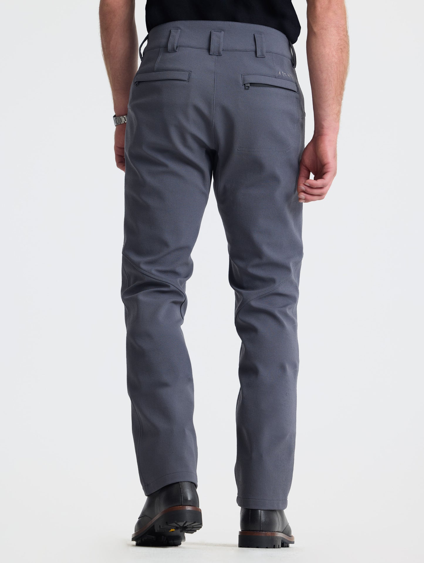 Rear lower-body view of man wearing Ramble Pant 3.0 in Graphite from AETHER Apparel.