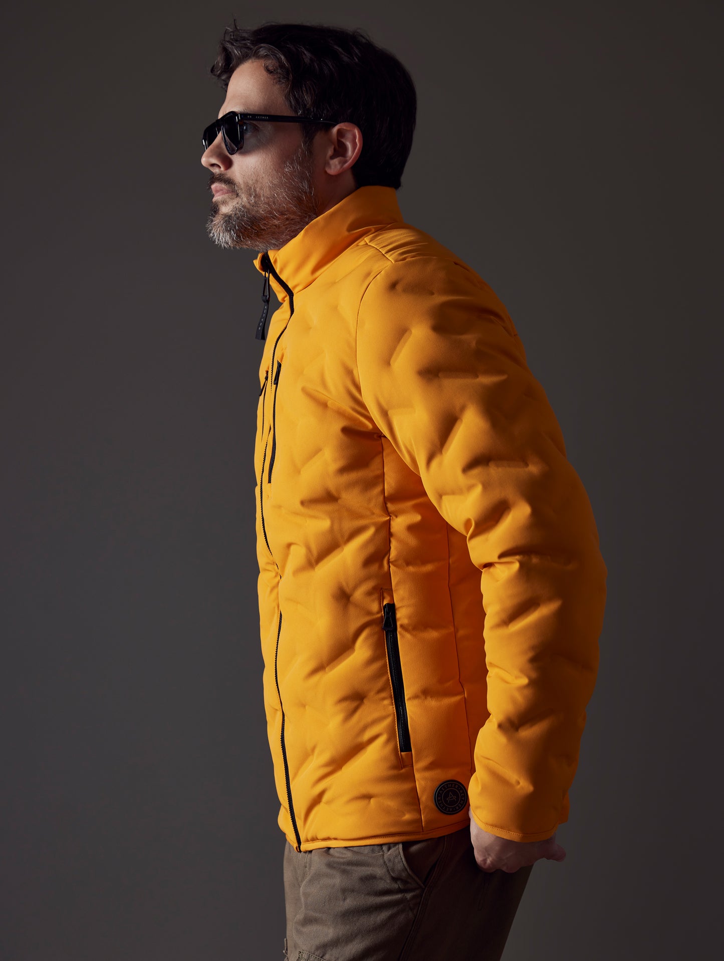 Man wearing orange insulated jacket from AETHER Apparel