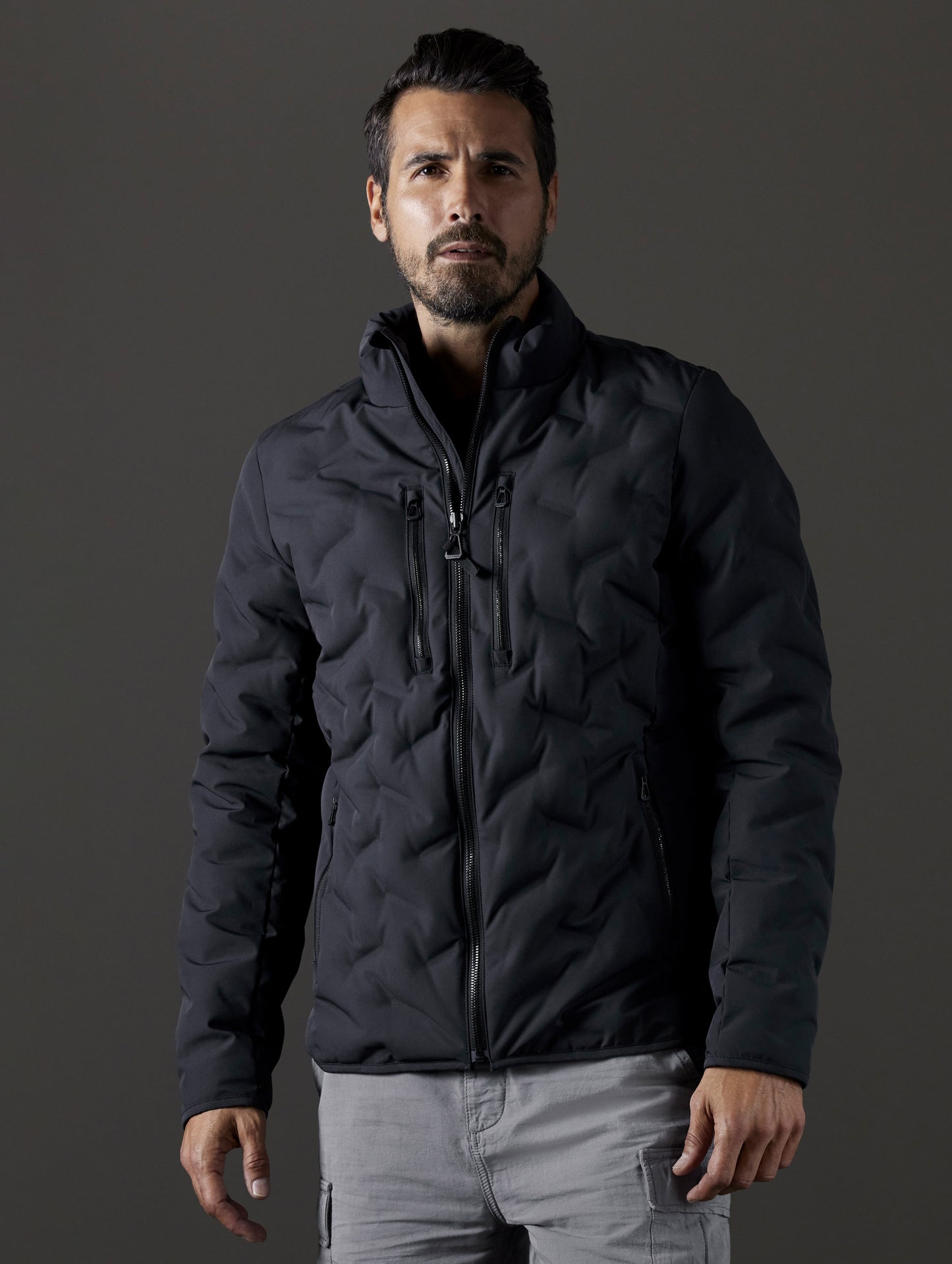 Front body view of man wearing Rex Down Jacket in Onyx Black  from AETHER Apparel.