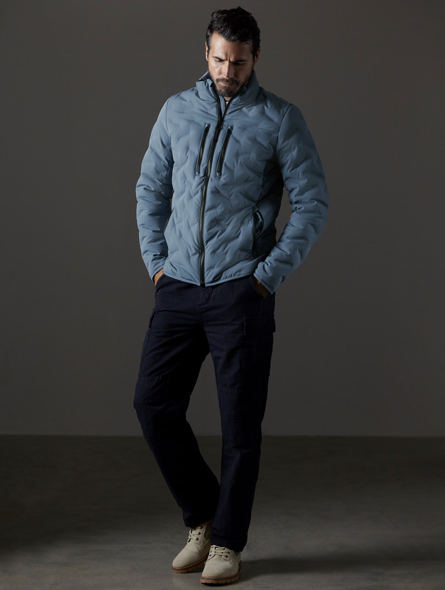 Front full-body view of man wearing Rex Down Jacket in Portal Blue from AETHER Apparel.