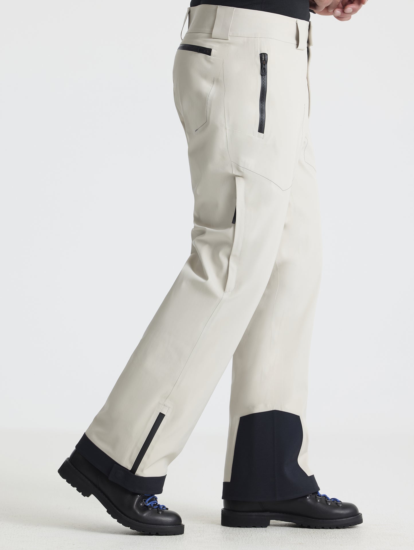 Side profile lower-body view of man wearing the Ridge Insulated Snow Pant in Bone from AETHER Apparel.